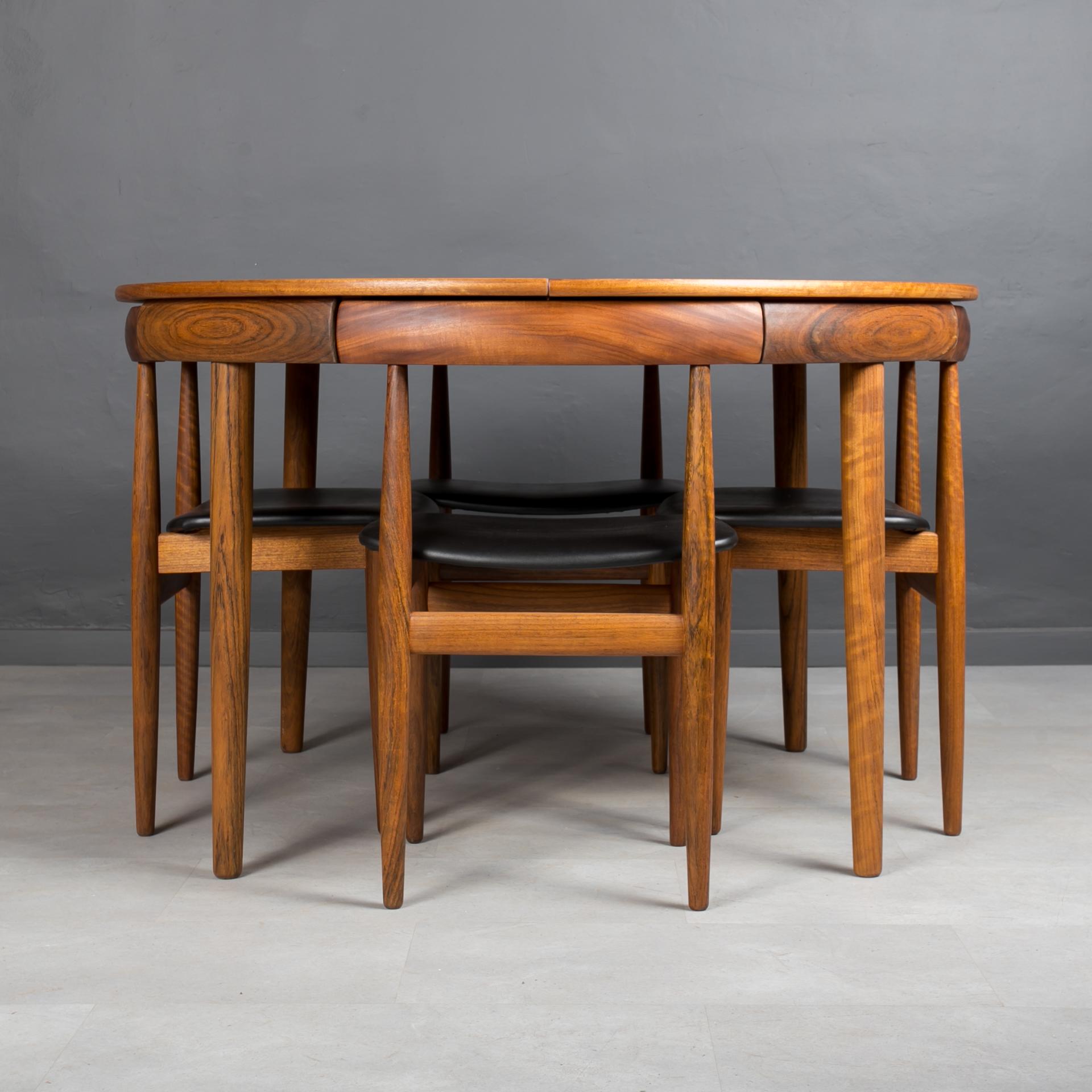 Rare “Roundette” dining set designed by Hans Olsen in 1960s. Produced in Denmark. This gorgeous dining set features an extendable teak wood round table and four dining chairs. The dining chairs seamlessly tuck into the table with their curved back