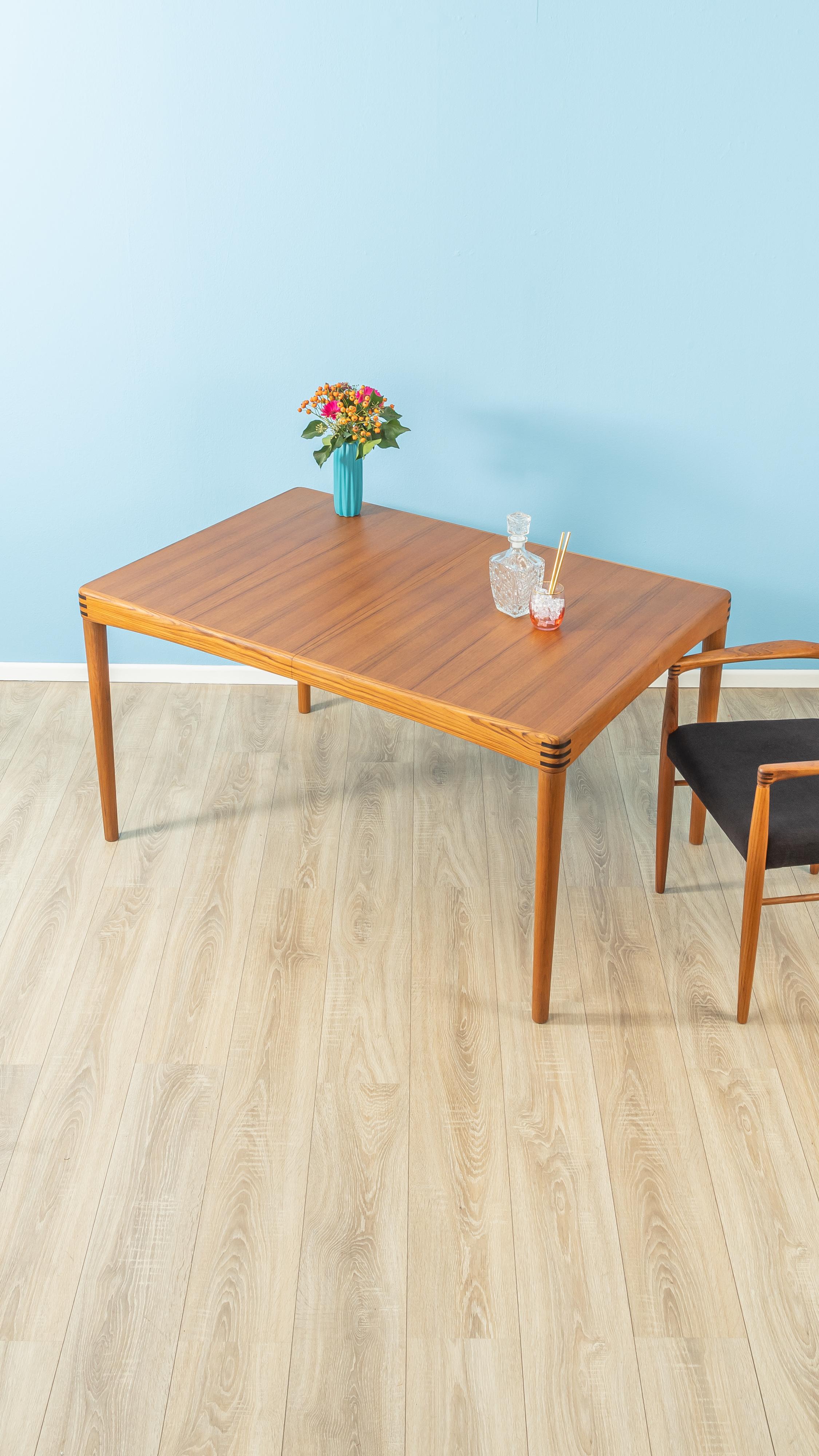 Classic teak dining table from the 1960s by H.W. Klein for Bramin. Solid frame and veneered table top with solid wood edge. The insert plate can be stowed under the table top.

Quality Features:
- accomplished design: perfect proportions and