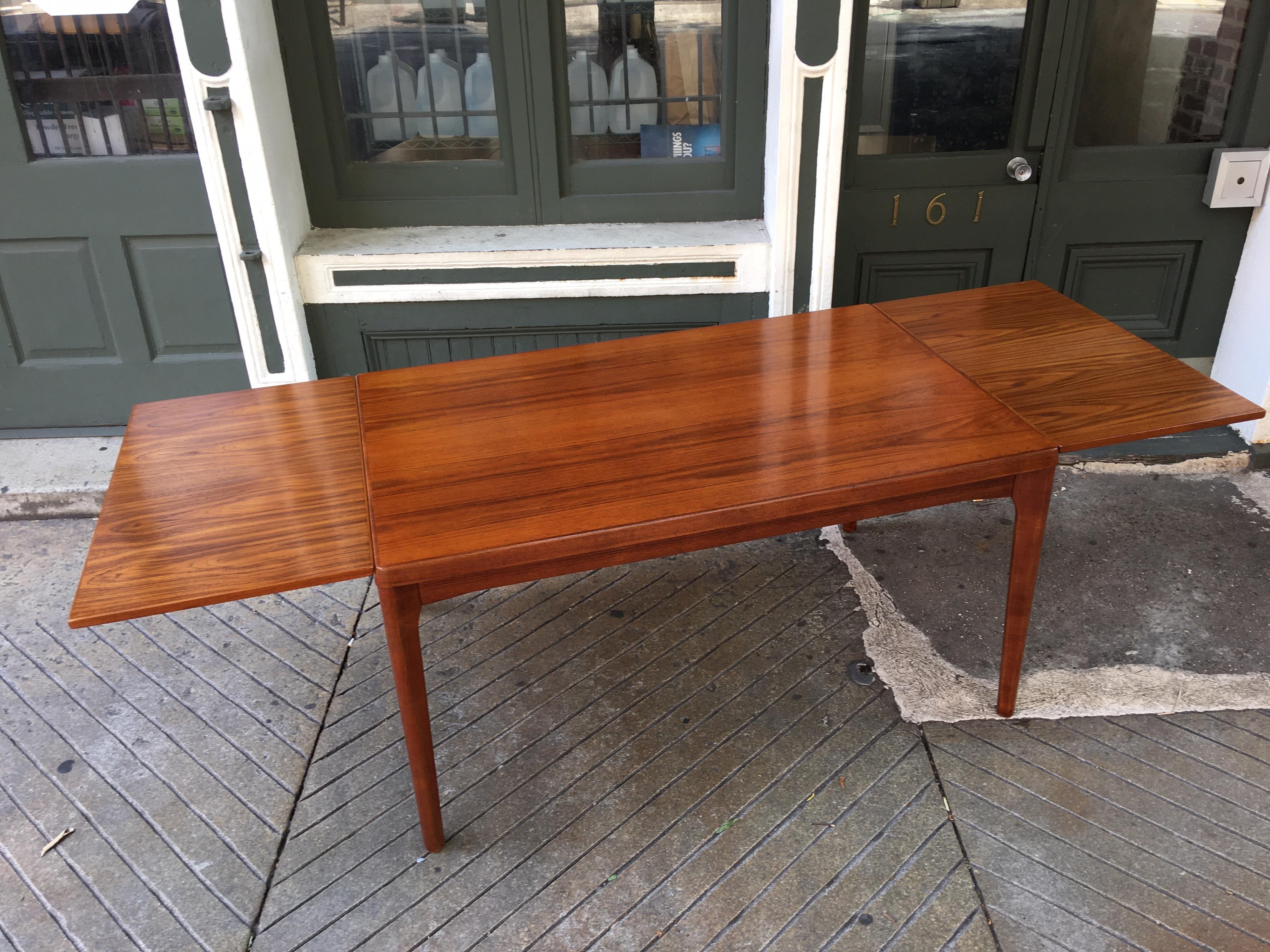 Teak Dining Table with Hidden Self Storing Leaves In Good Condition In Philadelphia, PA