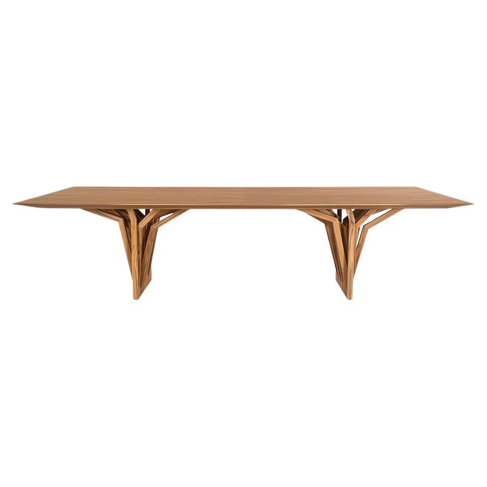 The Radi dining table designed by Sérgio Batista for Uultis presents a bold expression of contemporary design through a sculptural teak wood base that evokes the aerial roots of trees. *Please check availability prior to purchase*.

Topped with a