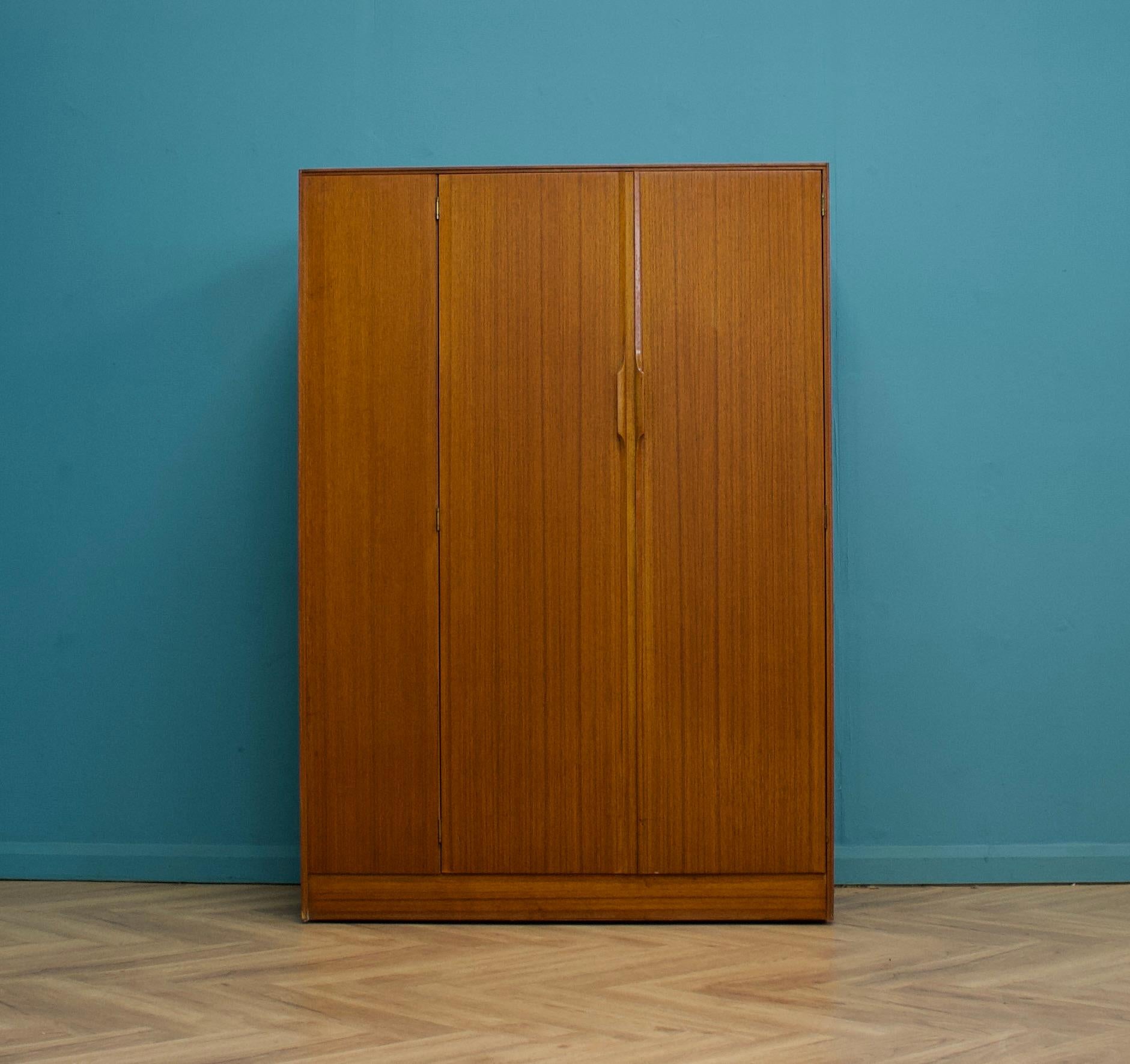 A freestanding double door teak wardrobe from Austinsuite
Made during the 1960s

Fitted out with a clothes rail
The style of this wardrobe is quite minimalist - with it's clean lines

This wardrobe will flat pack

The matching smaller wardrobe is