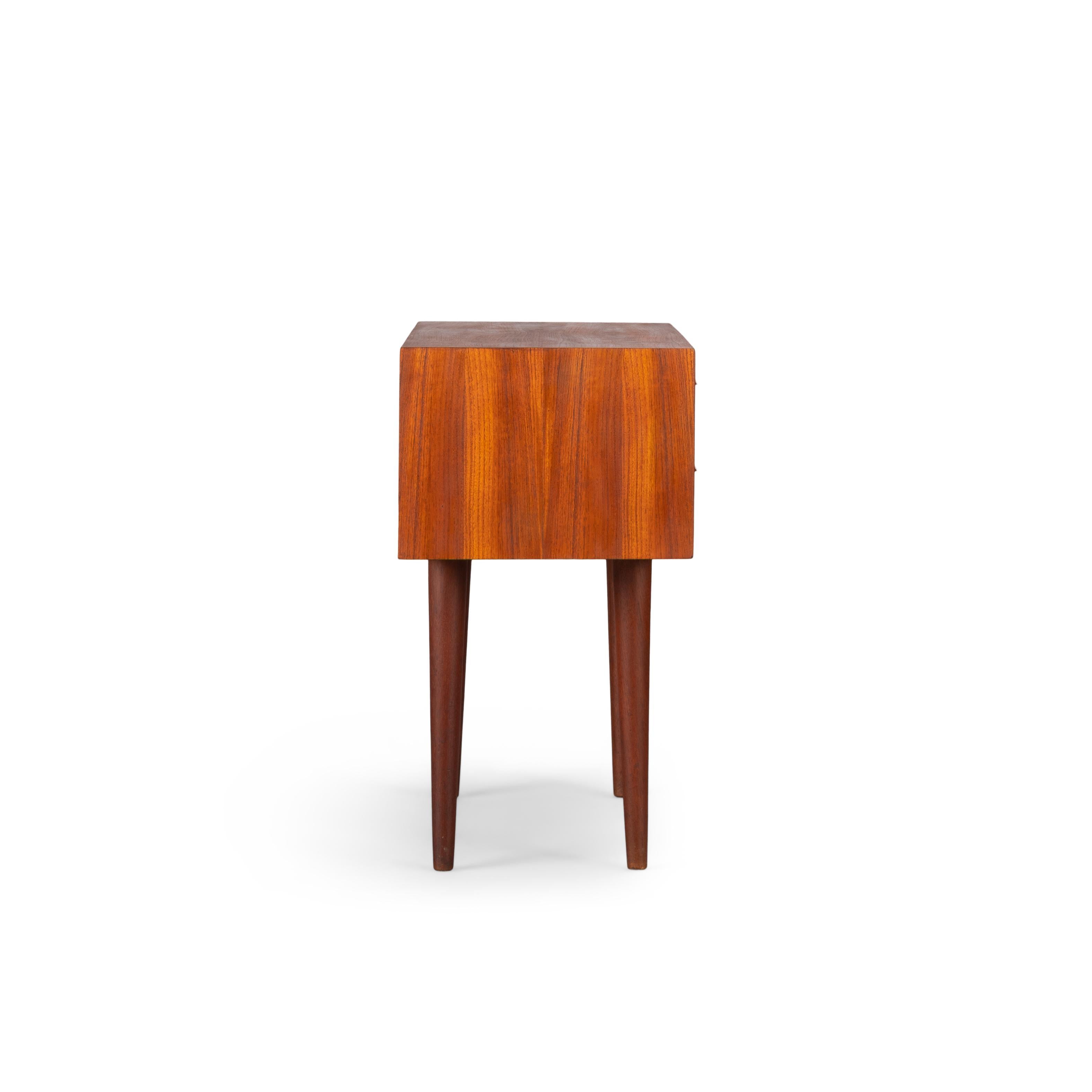 This stylish chest of drawers was designed by Kai Kristiansen and produced by Feldballes Møbelfabrik, Denmark in the 1960s. To be exact 29 March 1962. This cabinet is made of teak and has beautiful detailed lines with his signature eyelid handles,