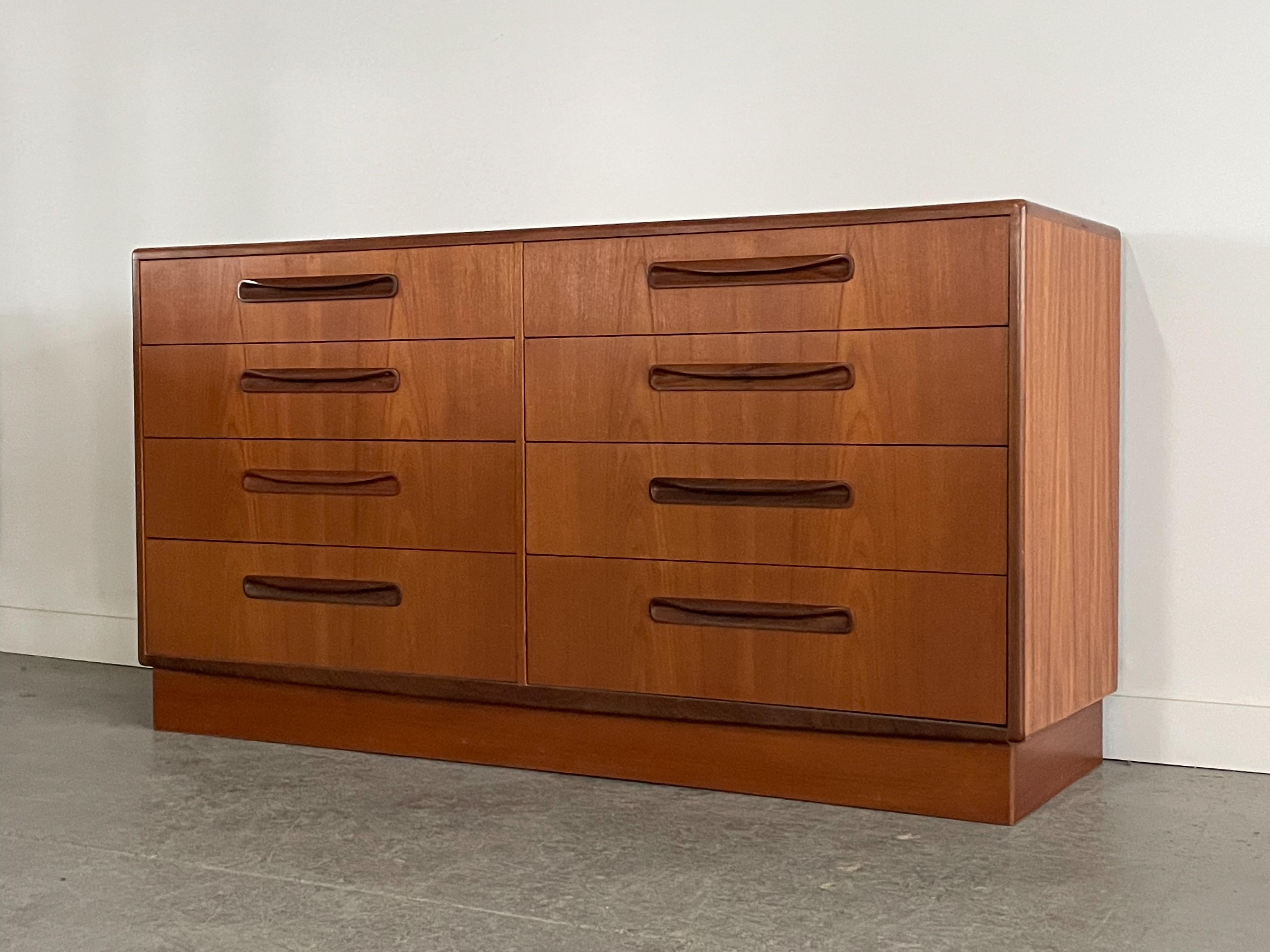 An absolutely stunning teak eight-drawer dresser from the ‘Fresco’ collection designed by V.B. Wilkins for G-Plan. This piece features beautifully sculpted afrormosia pulls and trim, and book-matched drawer fronts with nice dovetailing. Measures 56”