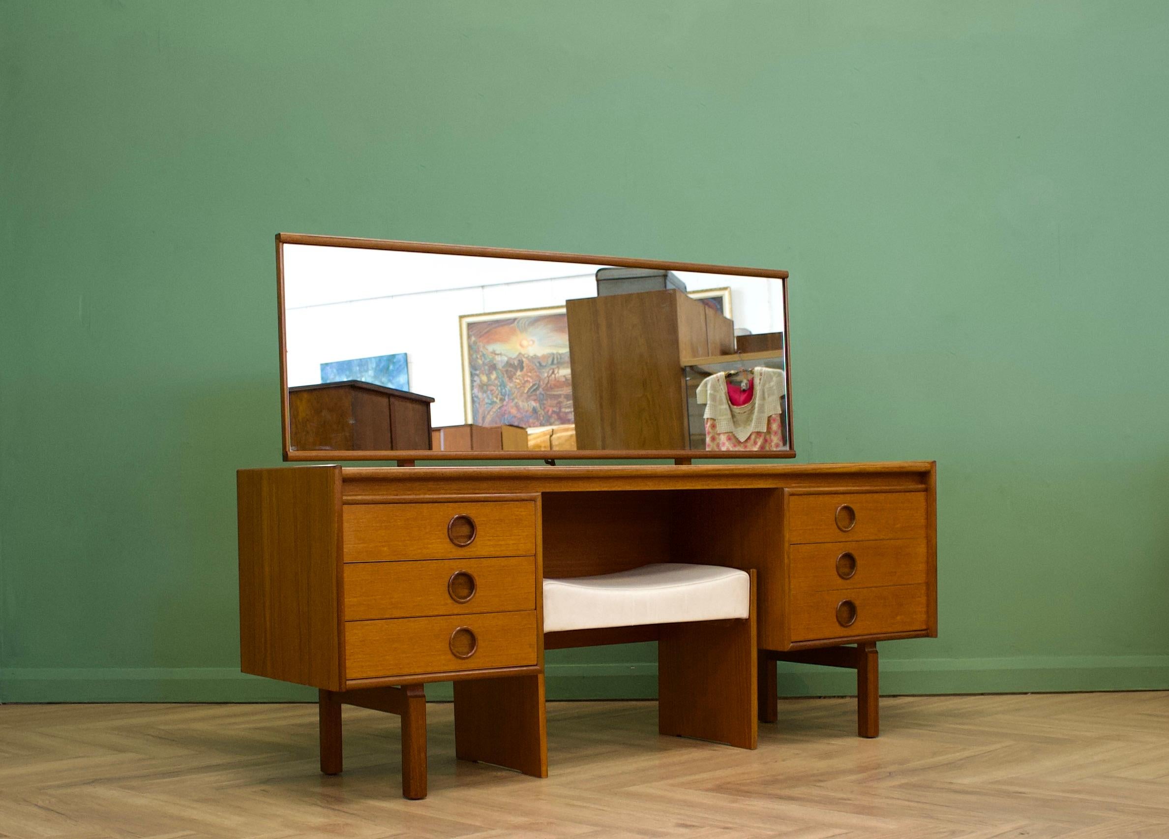A mid century teak dressing table from Bath Cabinet Makers - a high quality furniture maker - circa 1960's
Complete with a large mirror
There are six drawers in total - each having a recessed, solid teak, round handle
The piece stands on solid teak