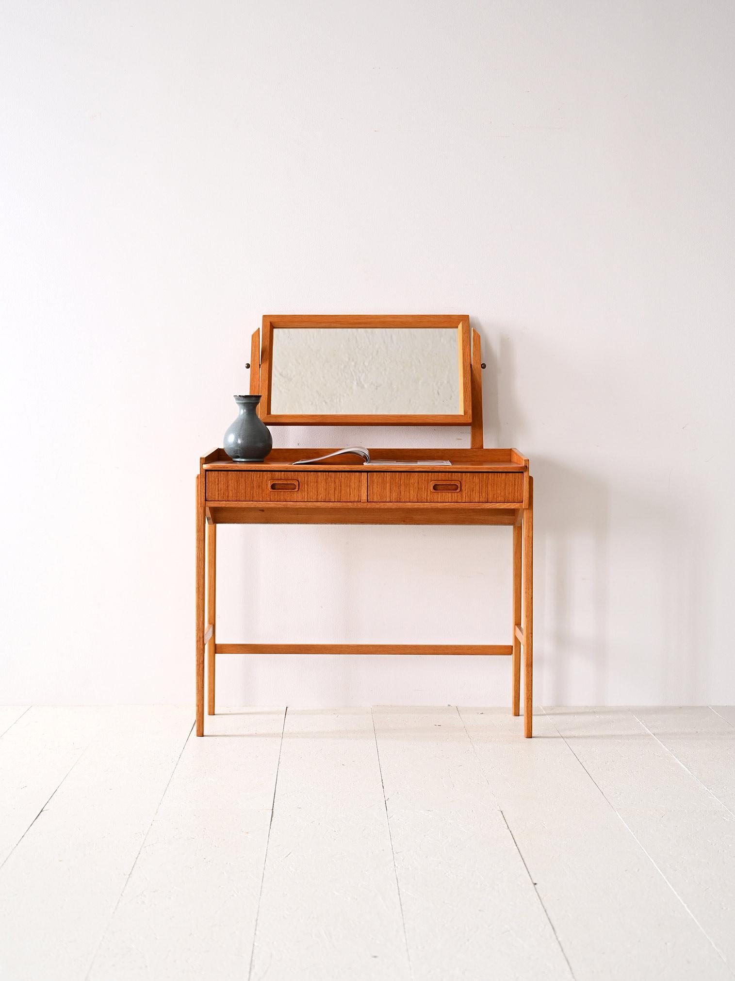 Vintage Scandinavian writing desk.

An original piece of furniture consisting of long squared legs and a top with two drawers supporting the mirror.
Perfect as a makeup station but also as a small space for smart working, this dressing table with an