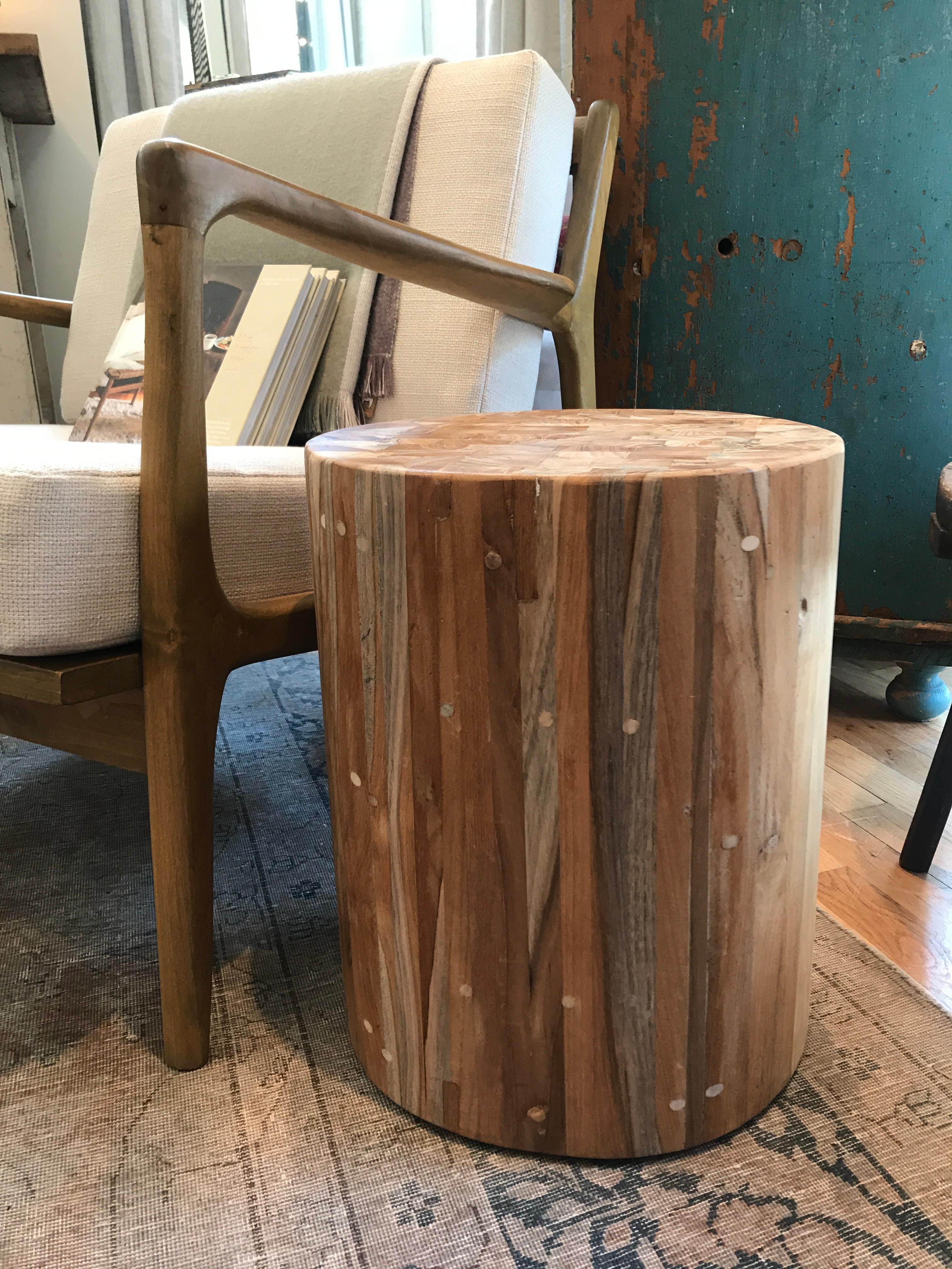 A subtle natural teak drum side table which can be versatility used as an ottoman, seat or stand for potted plants. Solid and very stabile.