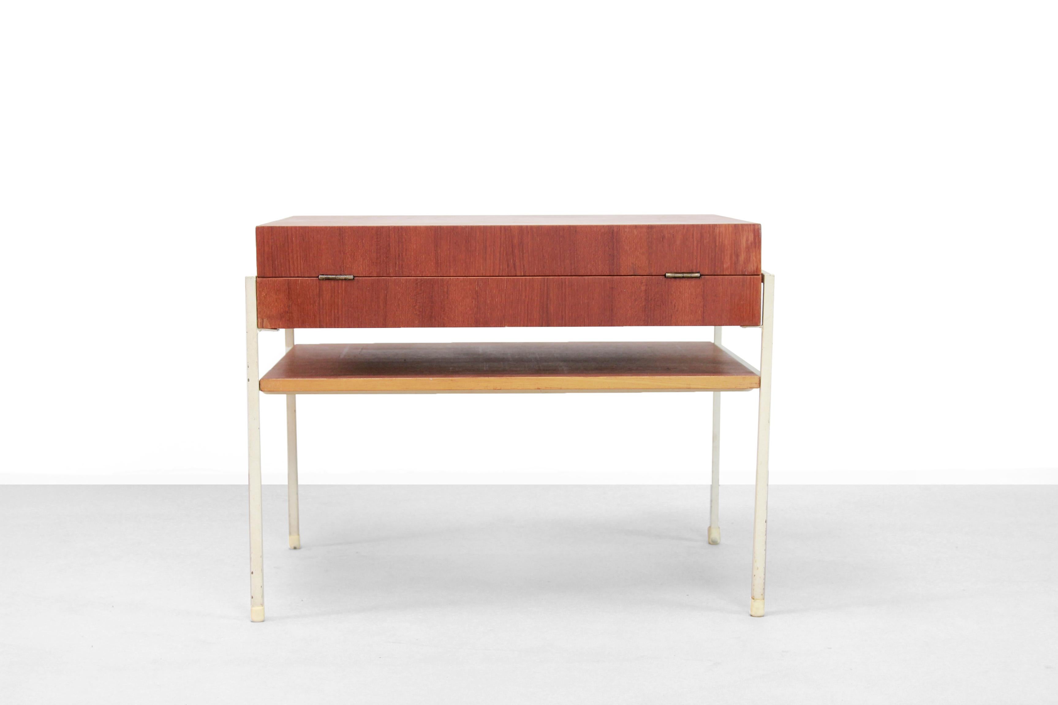 Super rare sewing table designed by Coen de Vries for Tetex, the Netherlands. Made from a white lacquered metal frame and a teak veneered cabinet. The way the cabinet can be opened is really beautiful. The two 'doors' at the top can be opened to the