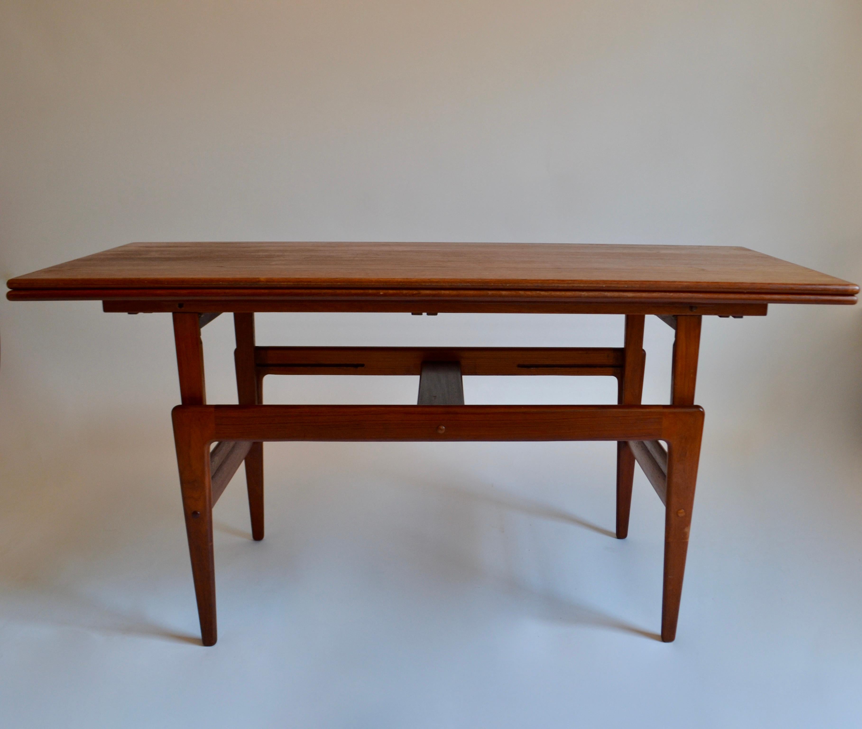 Metamorphic teak table designed by Kai Kristiansen during his time at Vildbjerg Møbelfabrik in Denmark, in the 1960s. With multiple functions, this table can serve as a coffee table in the day and be elevated to serve as a dining table in the