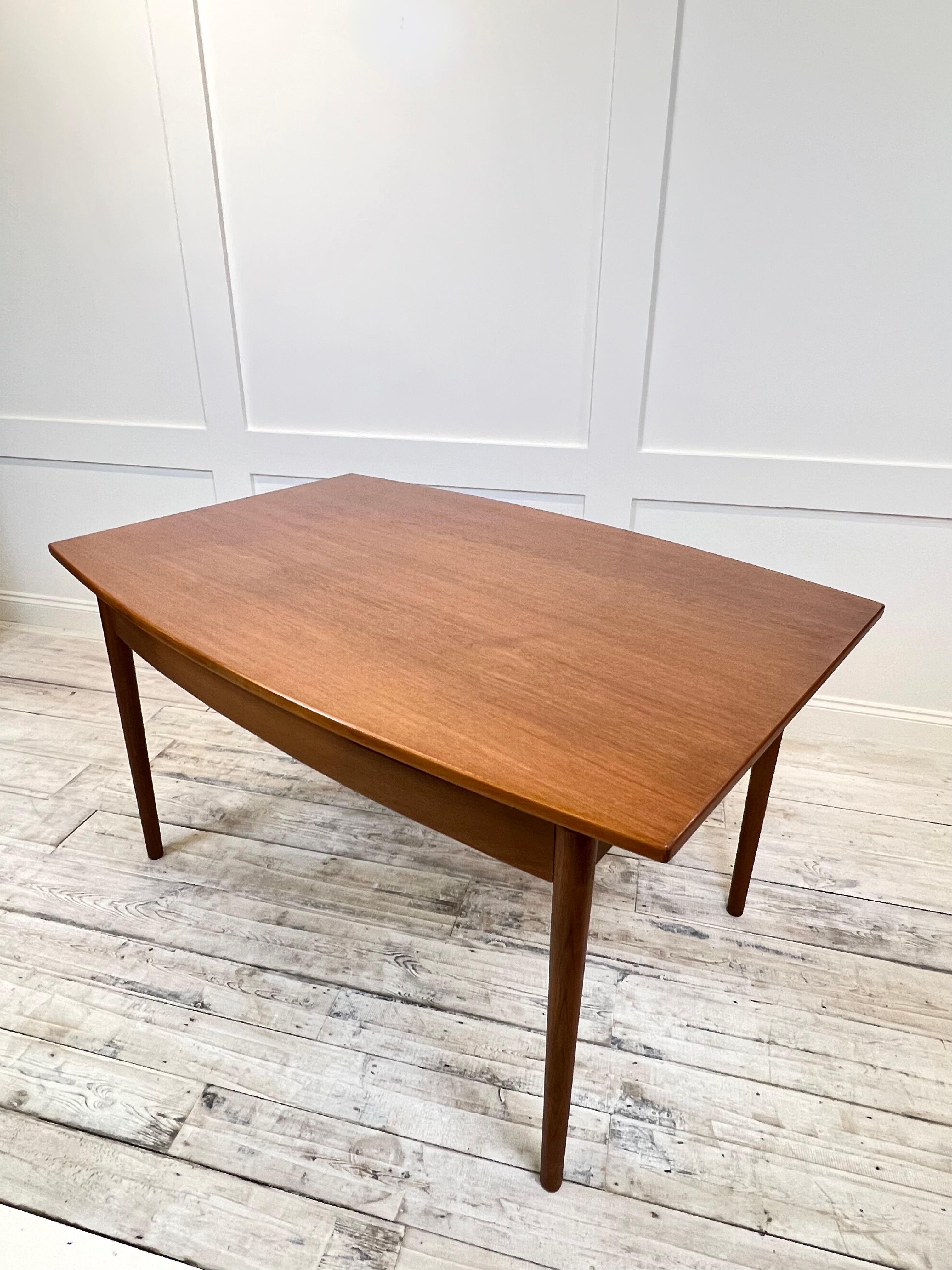 This vintage teak extendable dining table from G Plan UK, dating back to the 1960s, exudes timeless elegance and functionality. With its rich teak wood construction and sleek mid-century modern design, this table is a show-stopping centrepiece for