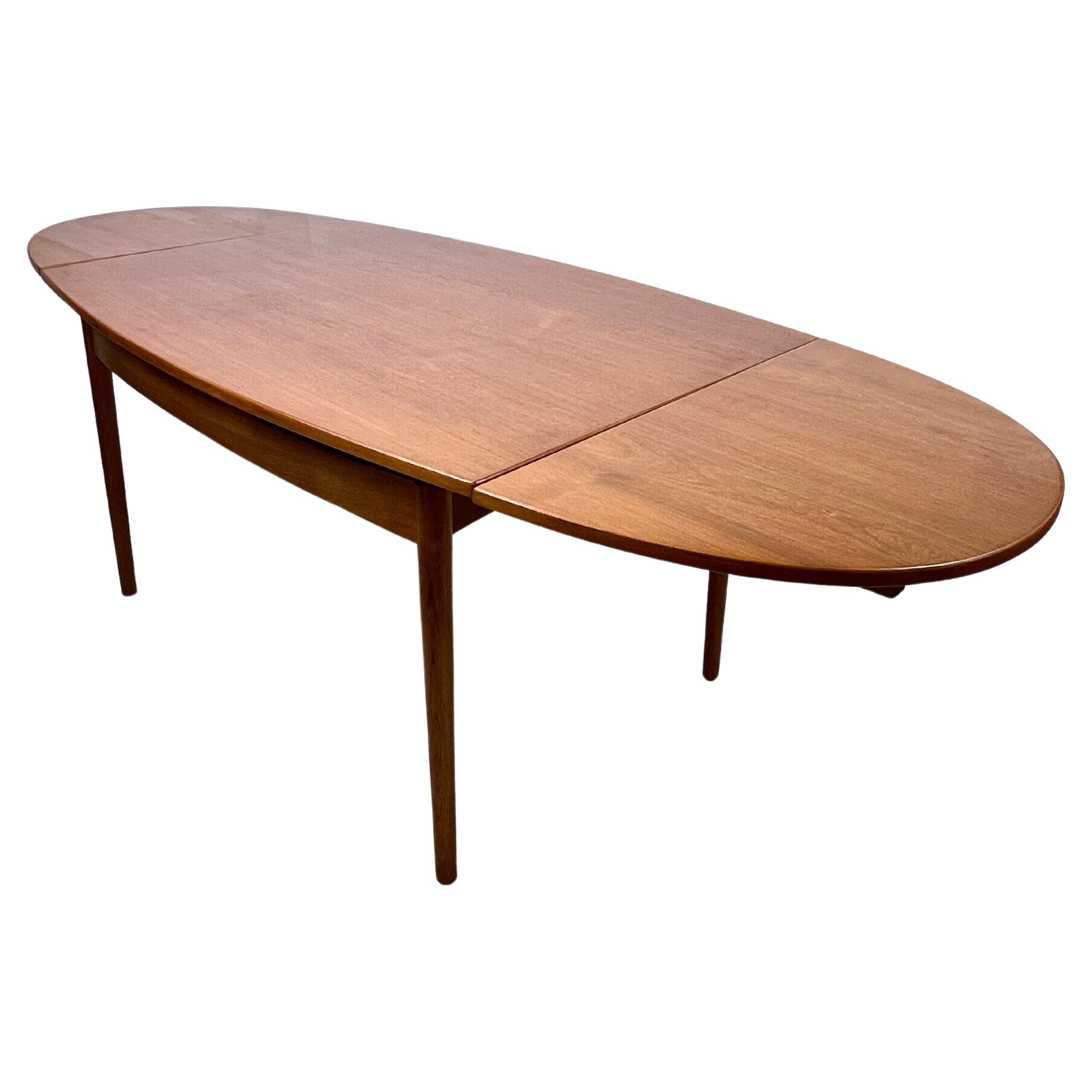 This vintage teak extendable dining table from G Plan UK, dating back to the 1960s, exudes timeless elegance and functionality. With its rich teak wood construction and sleek mid-century modern design, this table is a show-stopping centrepiece for
