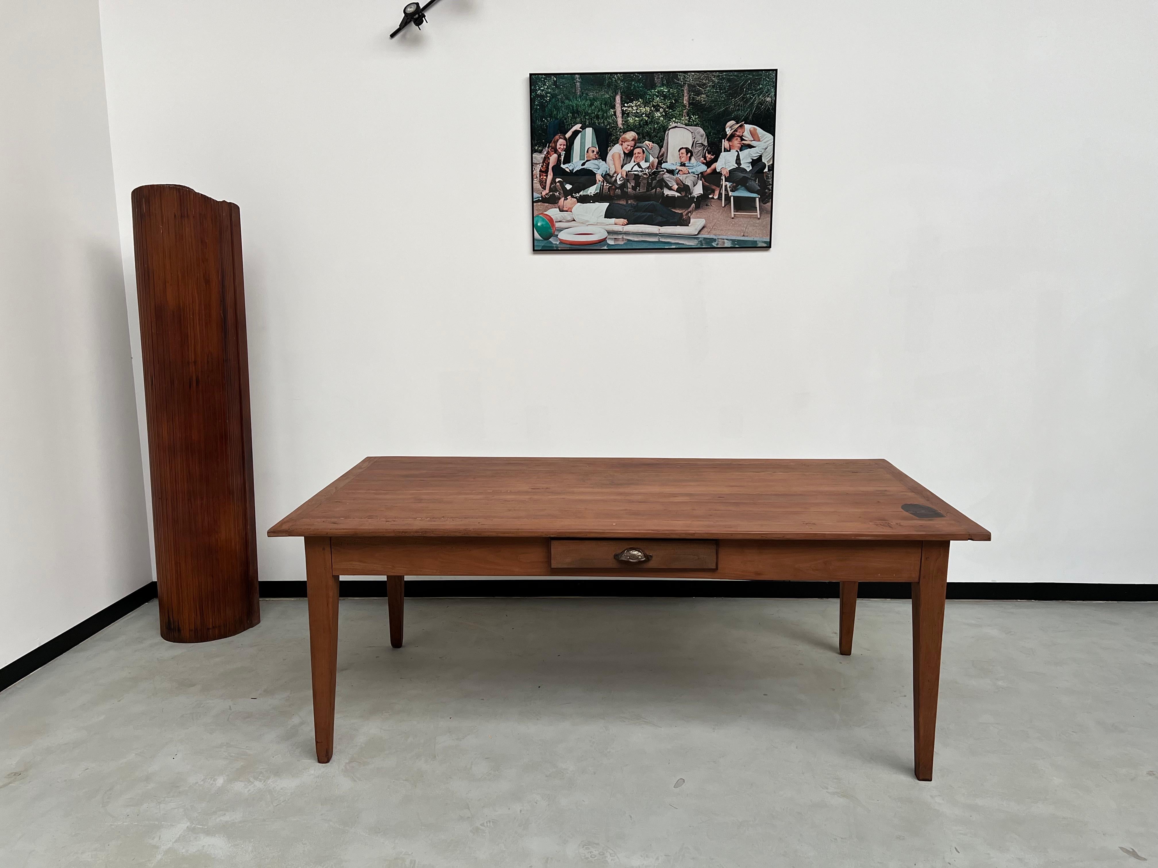 This teak table (exotic wood) is very practical with its huge drawer located on one end and its other drawer on the front and is also very beautiful with its airy look provided by the spindle legs. Its great depth also makes it ideal for family or