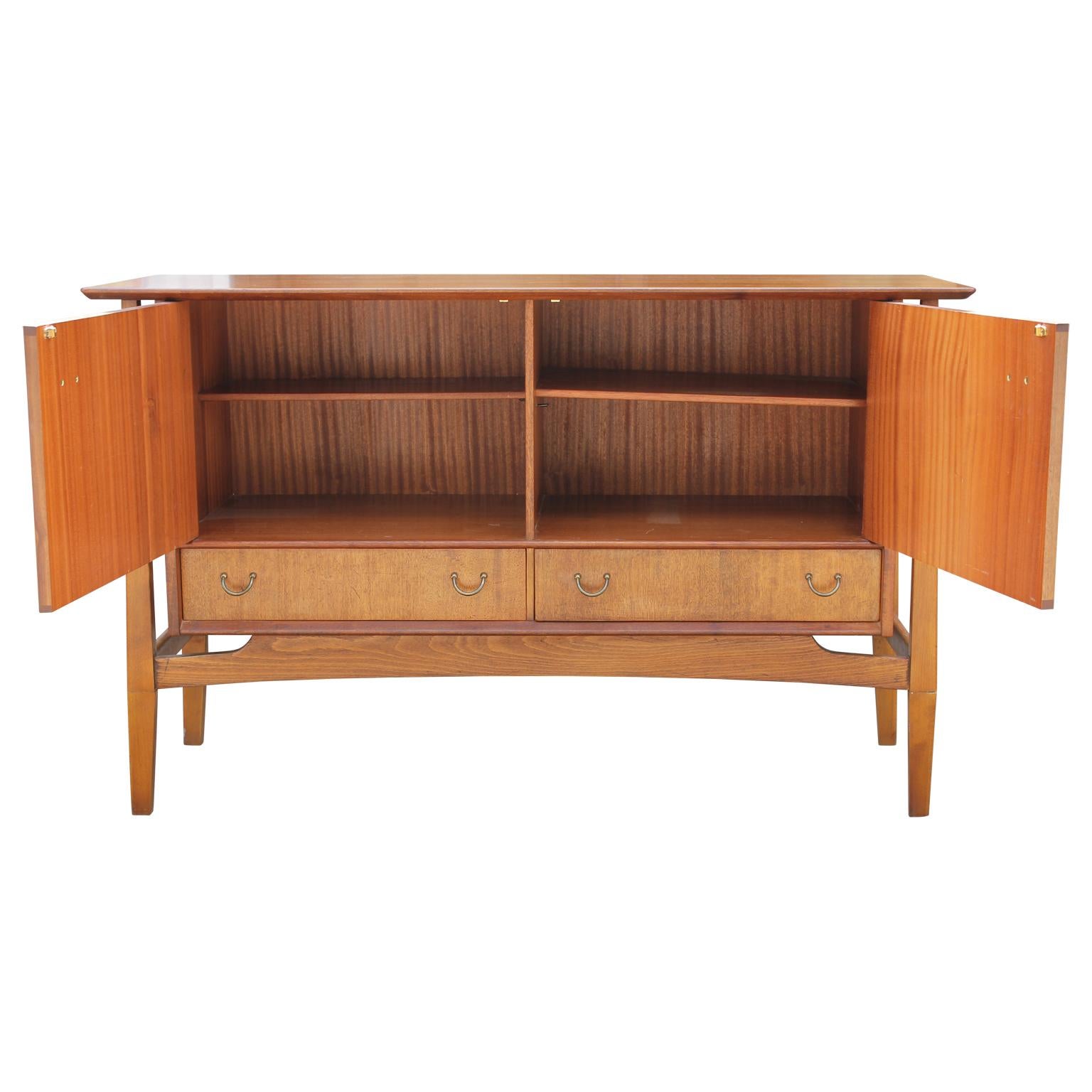 Four shelves teak sideboard or credenza with two pullout / pull-out drawers. The maker's mark is stamped inside the drawer. The floating top is a nice structural accent making this credenza look clean and unique.
