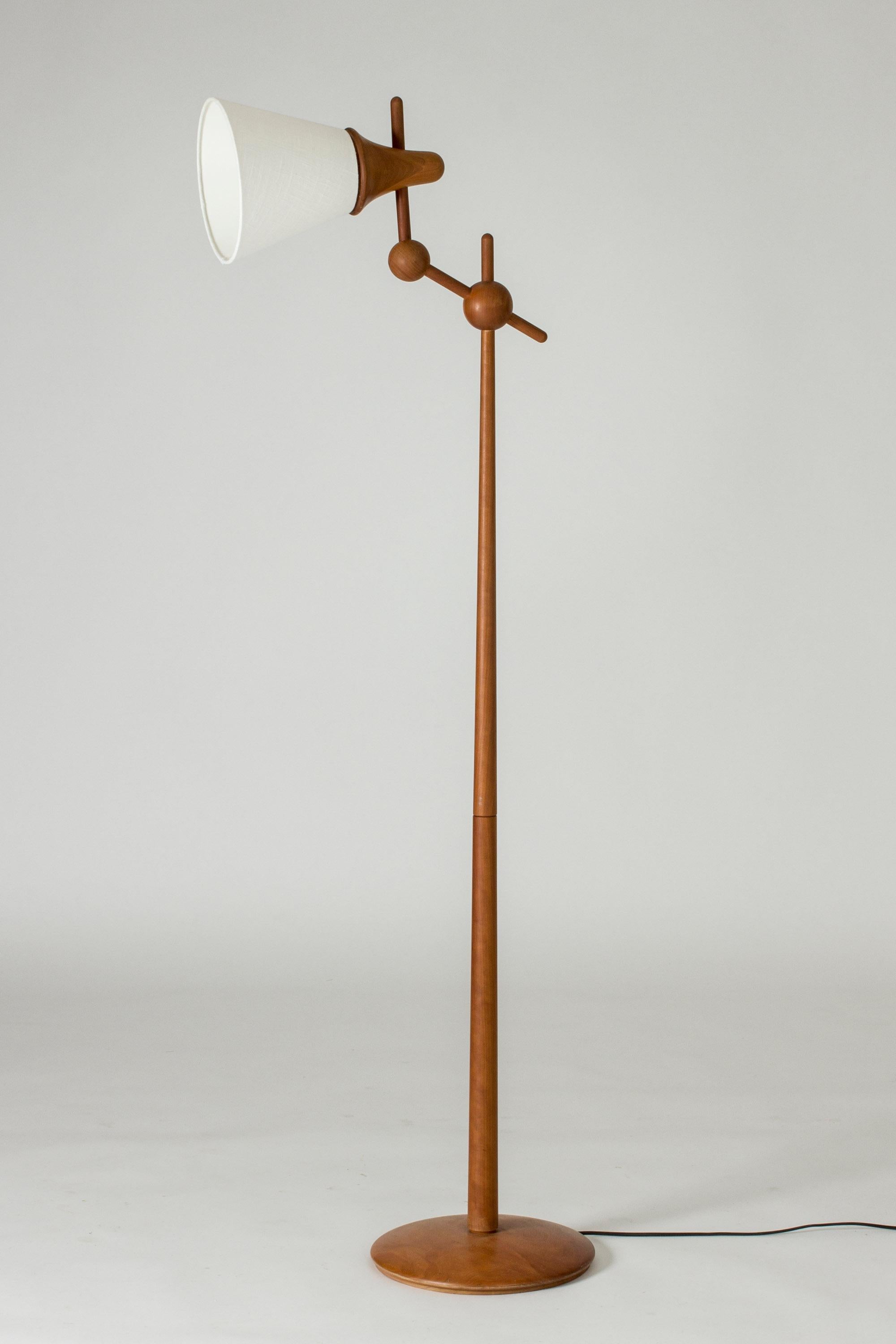 Cool floor lamp from Haslev, made from teak. Chunky, smooth design with round details. The shade can be turned in different angles.