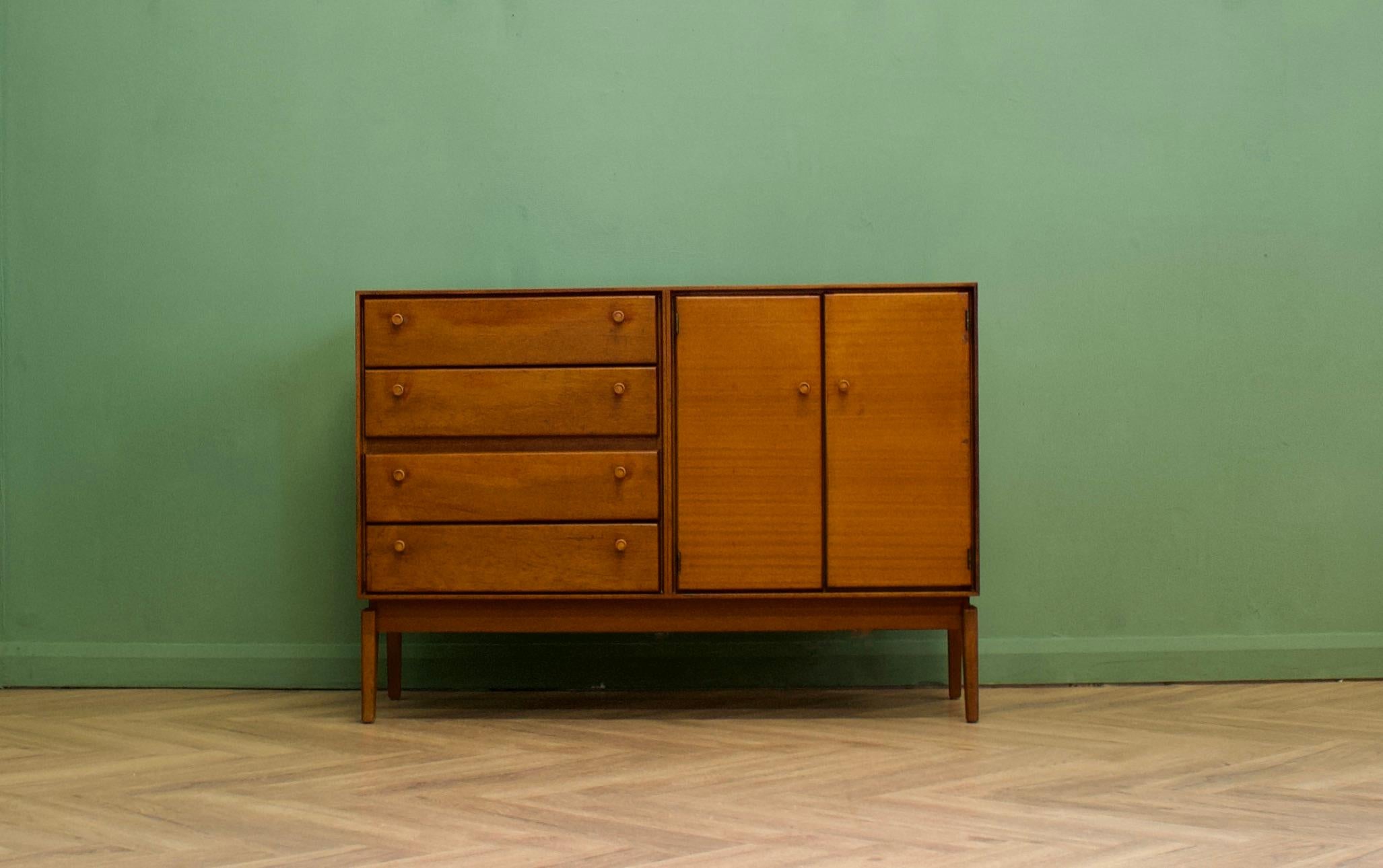A mid century teak sideboard from Minty Library Specialists Oxford, circa 1960s

Featuring 4 drawers and a cupboard