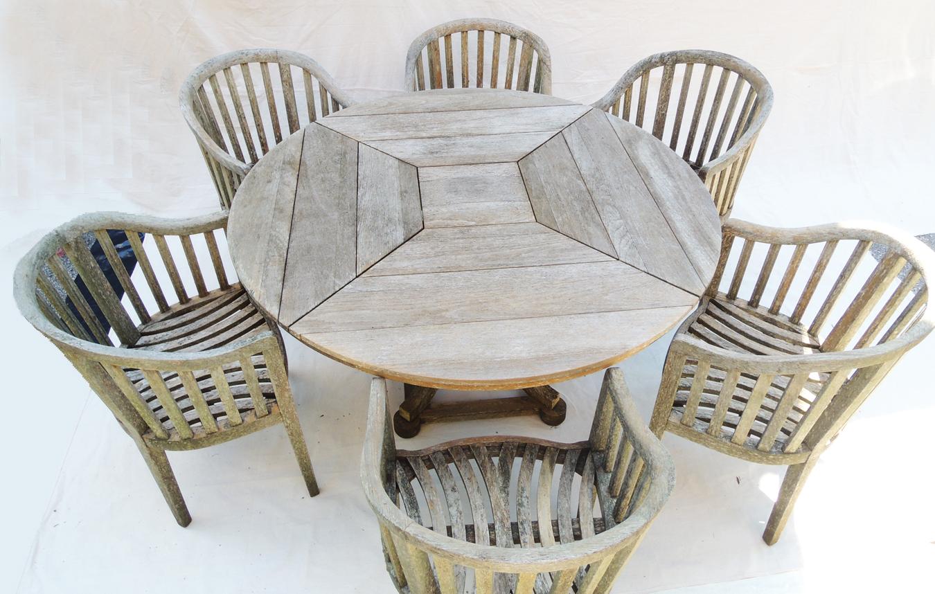 A garden set having a beautiful patina by John Danzer, Munder-Skiles Co., Chatham, NY. Large round table and 6 chairs. All that would be needed are cushions in your chosen fabric. Solid construction in very good condition. Aged to perfection in a