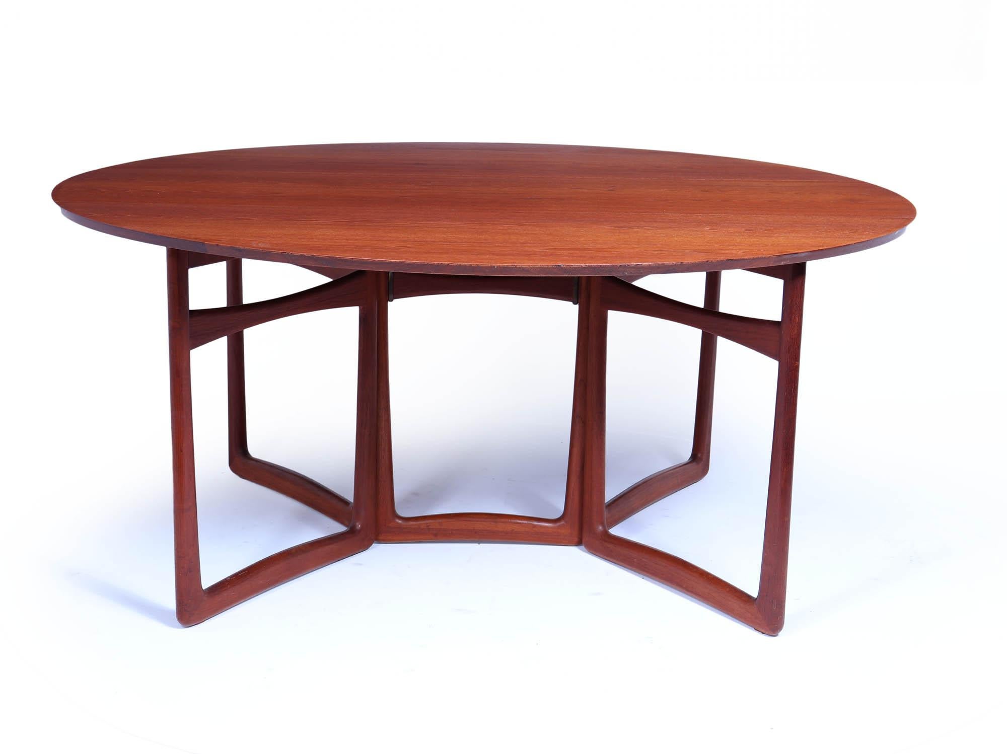 Teak Dining Table by  France and Son
A large teak dining table designed by the renowned duo Peter Hvidt and Orla Molgaard Nielson in the 1950s. Crafted by France and Son in the 1960s, this exceptional piece showcases a stylish gate leg design that