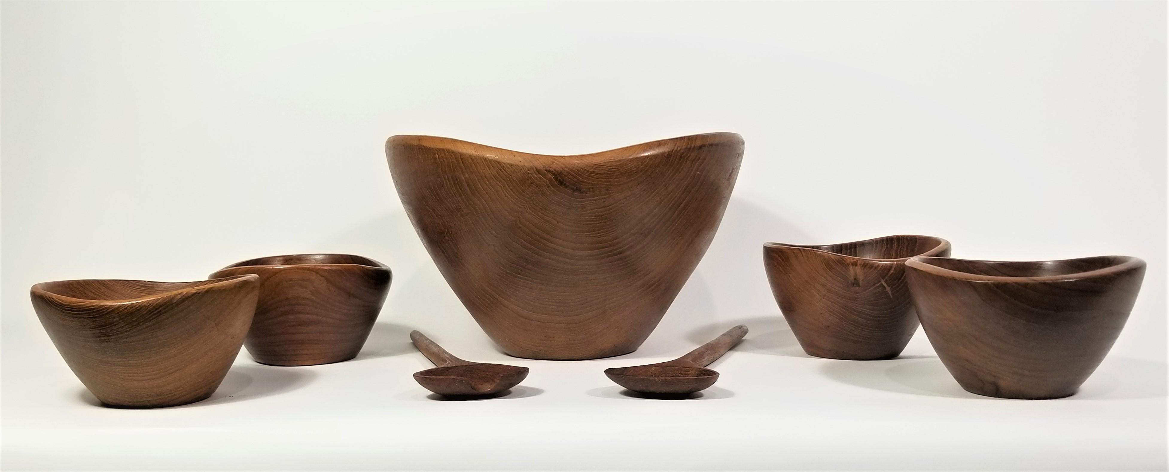 Mid century 1960s teak hand turned bowl set.  1 large bowl and 4 small bowls with utensils. 

Measurements:
Salad bowl height: 7.5 inches
Salad bowl diameter: 12.0 inches

Small bowls height: 3.25
Small bowls diameter: 5.75 inches

Salad spoons