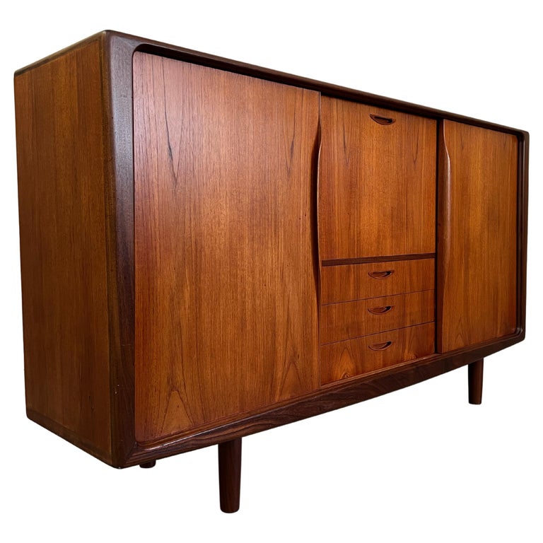 Danish Modern teak high board / Credenza by H.W. Klein for Bramin with sculpted Door pulls and drawers. The legs are original ,but were made shorter at one time.