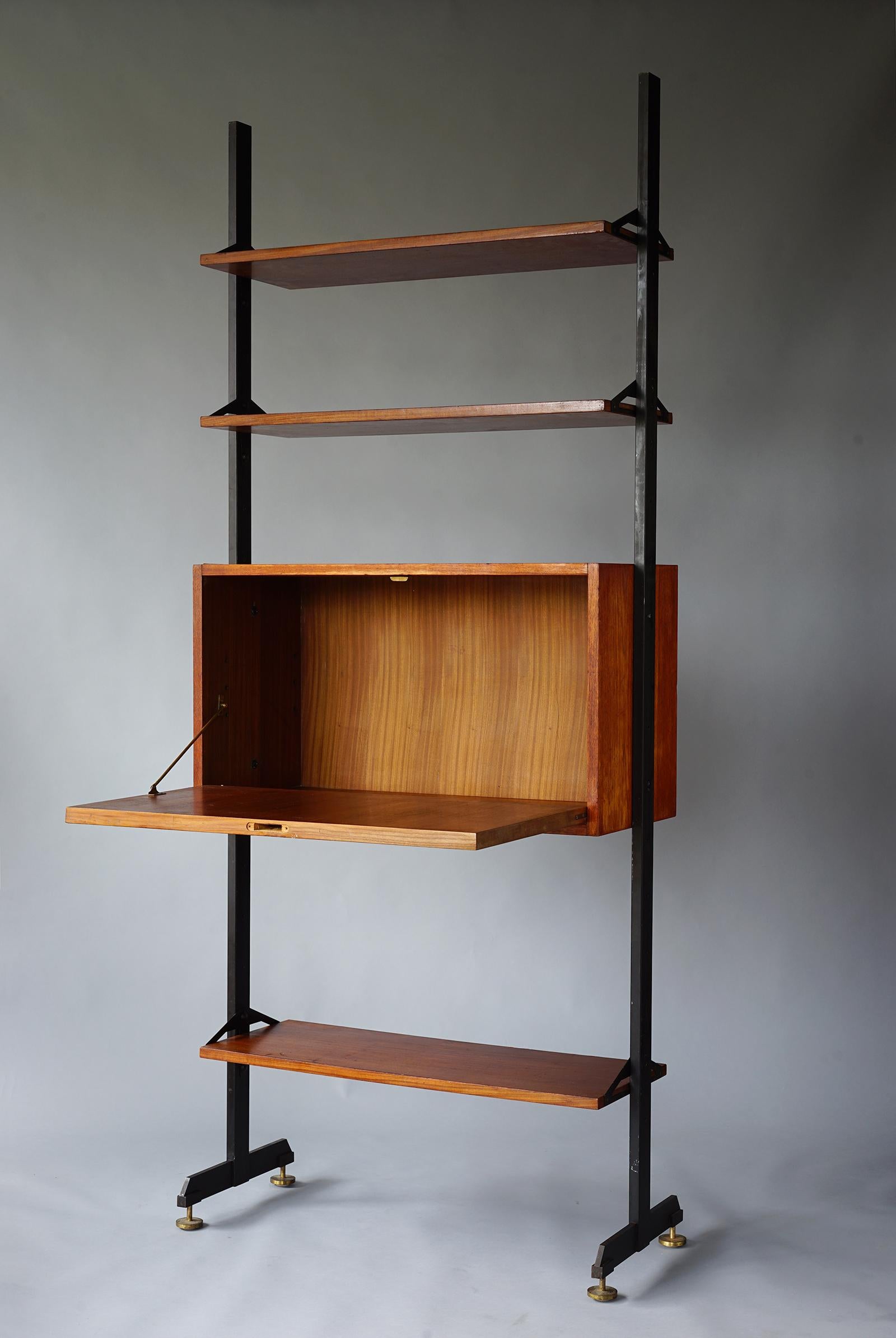 Handsome unit featuring three adjustable shelves and flip down cabinet mounted on freestanding metal rails with adjustable brass feet. Missing lock to cabinet.