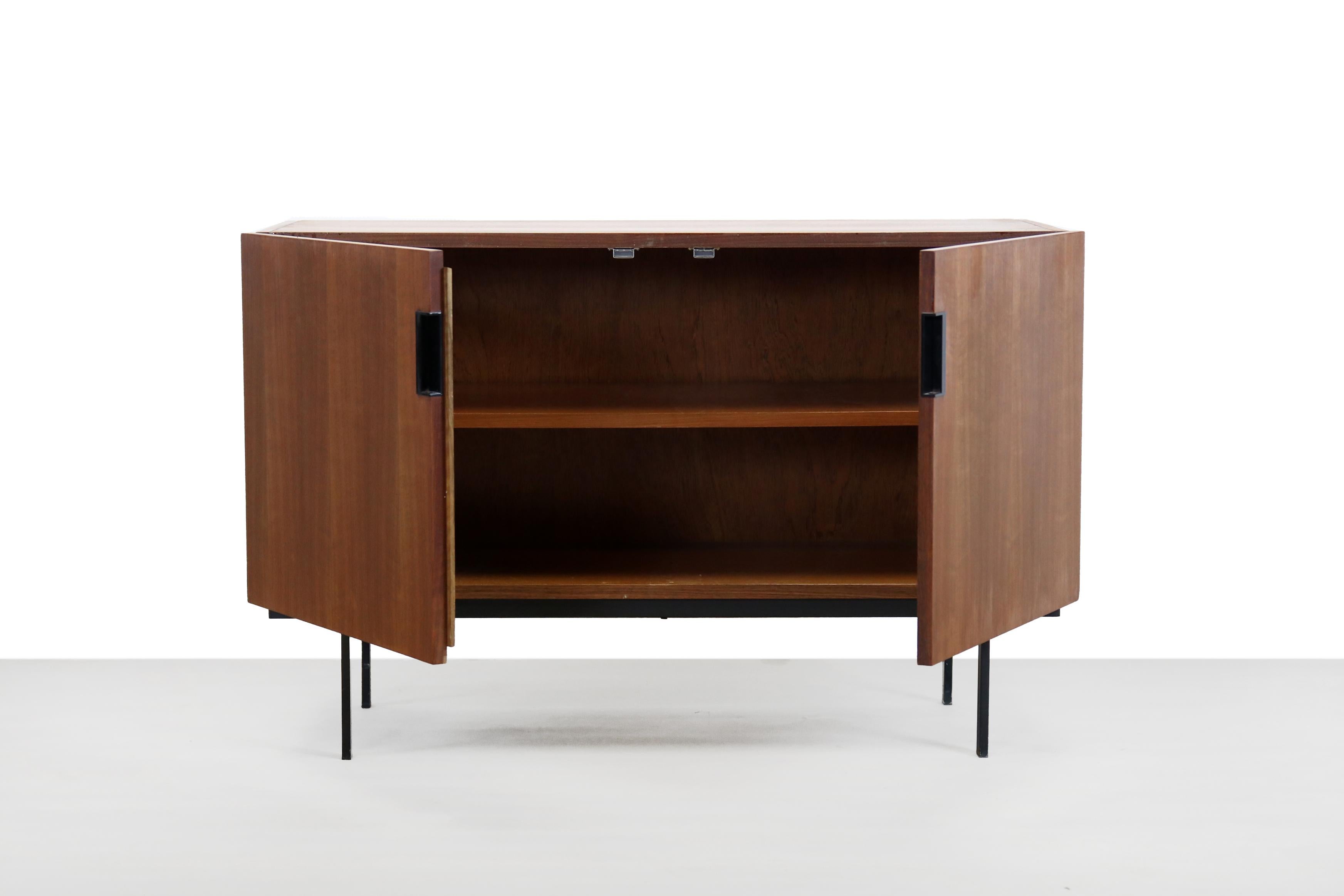 Beautiful sideboard from the so-called Japanese Series designed by Dutch designer Cees Braakman and manufactured by UMS Pastoe, The Netherlands 1950. This cabinet is not only beautiful but also offers a lot of storage space. The teak cabinet has two