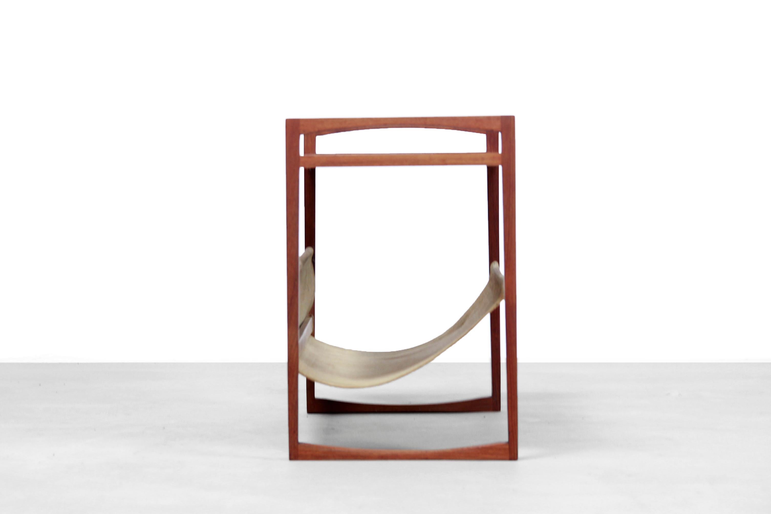 Danish design magazine rack and side table designed by Kai Kristiansen for Sika Møbler in Denmark in the 1960s. The lower compartment for magazines is made of suede. The table is made of solid teak and has beautiful details. For example, look at the