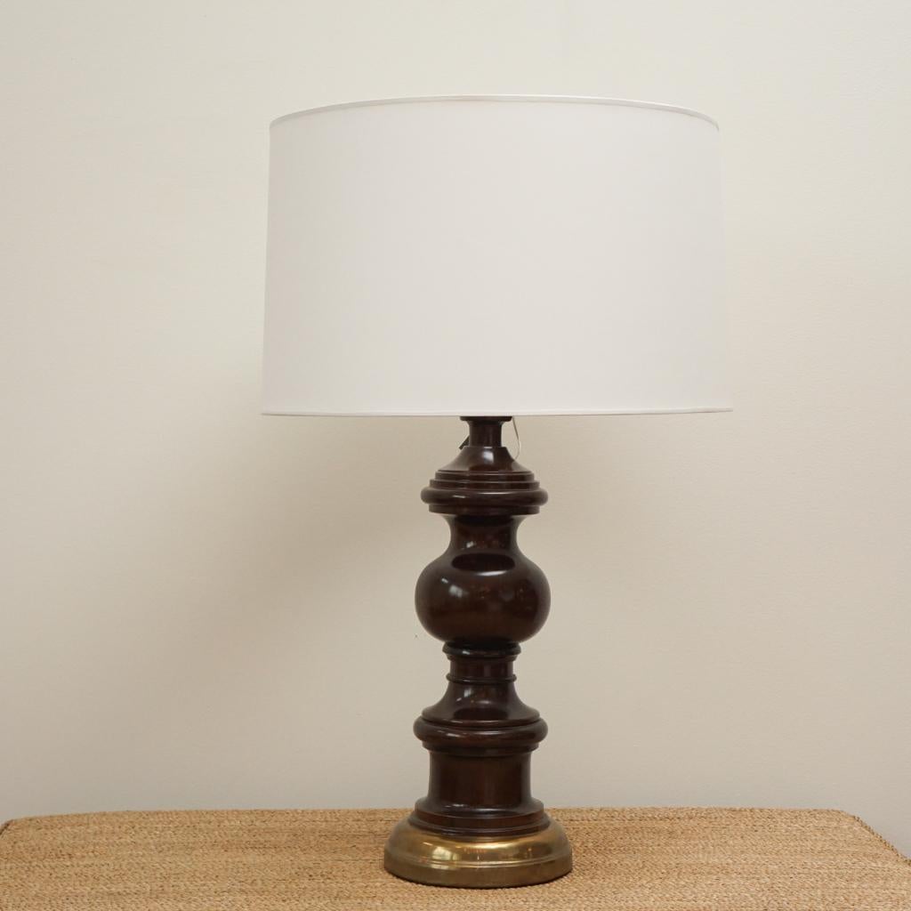 Solid turned-base teak lamp with brass accents. White paper shade included. Sleek design and elegeant lines in the teak, give this lamp a very rich look. Stunning larger scale lamp to brighten up your space. 