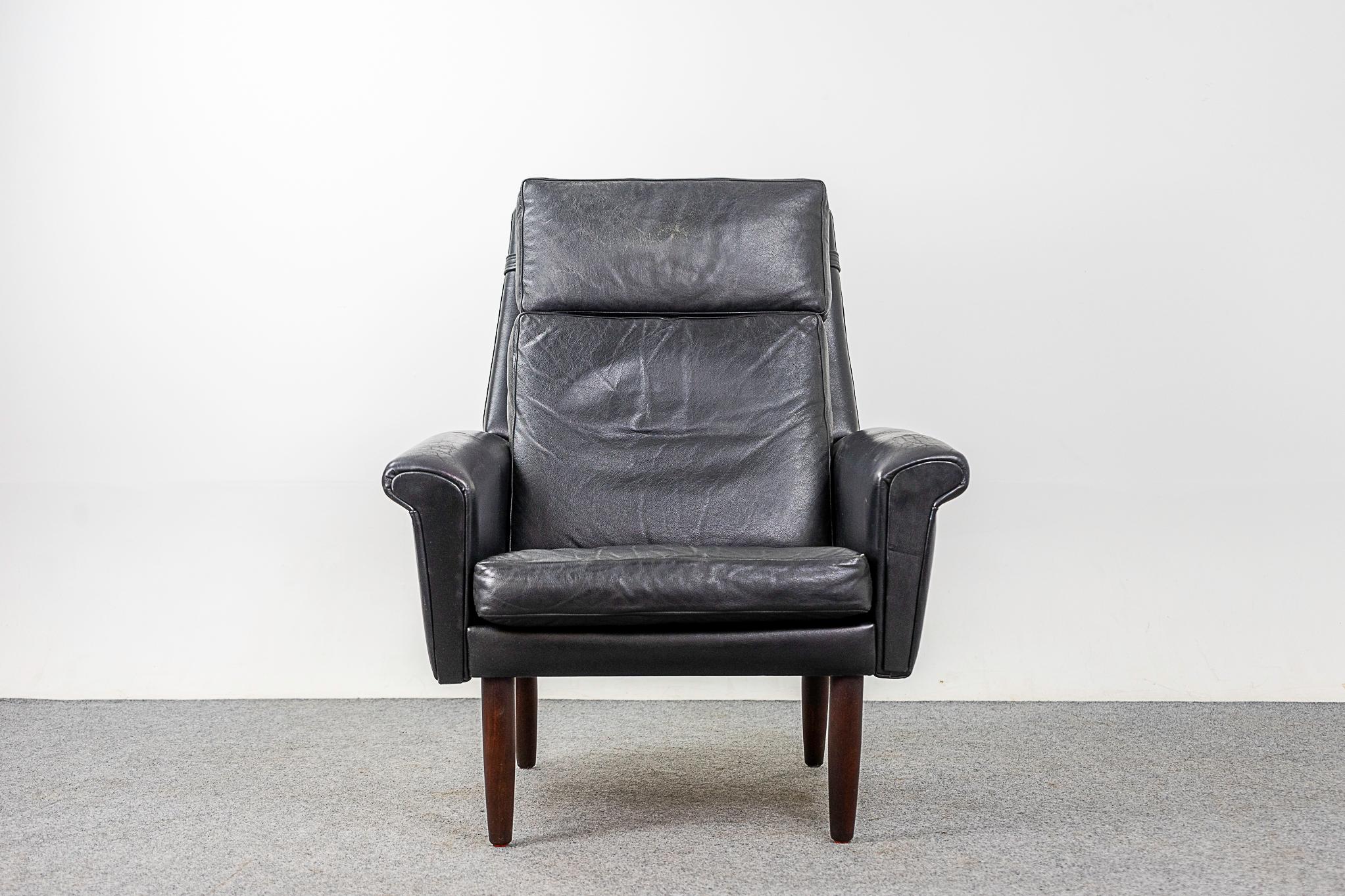 Leather & teak mid-century lounge chair, circa 1960's. Original pitch black soft, supple leather with only minor some marks consistent with age. Sultry angles and solid teak turned legs. High back provides exceptional neck support, a very