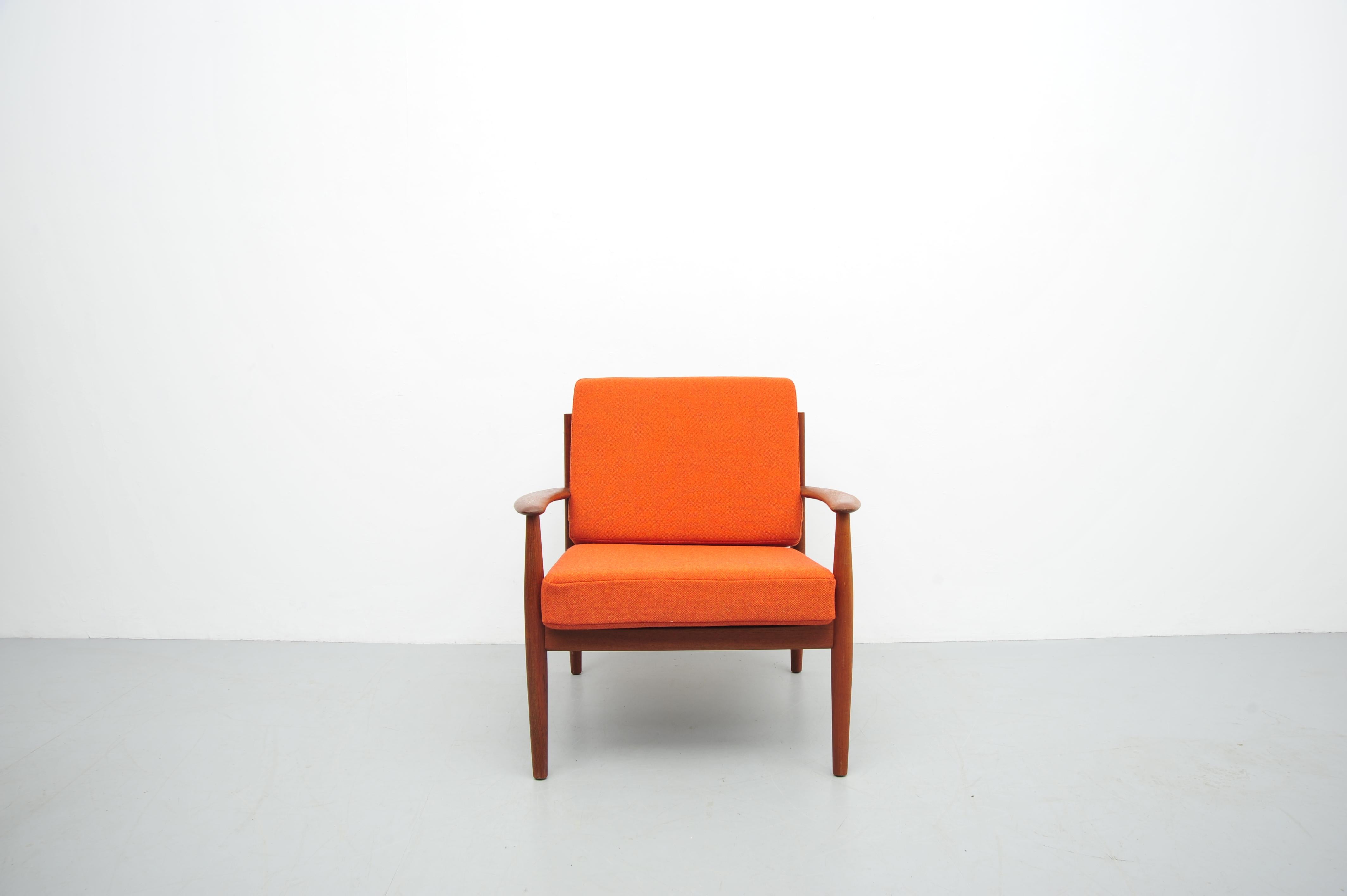 This elegant lounge chair, designed by the esteemed Danish designer Grete Jalk for France & Son in the 1960s, exemplifies the timeless appeal of Scandinavian mid-century modern design. Crafted from solid teak wood, the chair features a gracefully