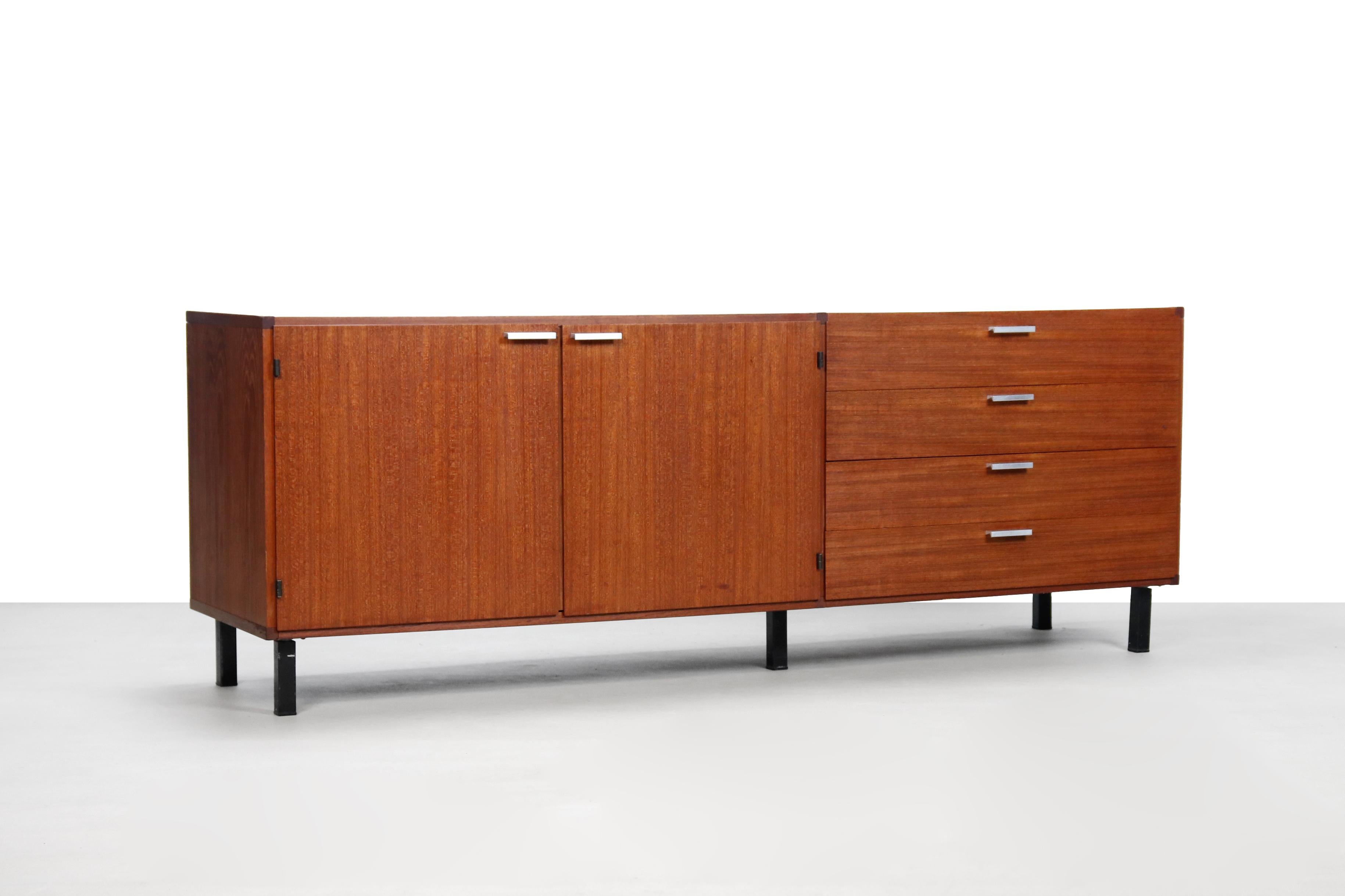 Beautiful teak sideboard designed by Cees Braakman for Pastoe. This sideboard comes from the made to measure series where stainless steel handles are used. This sideboard consists of two teak doors and 4 curved plywood anti-dust drawers.