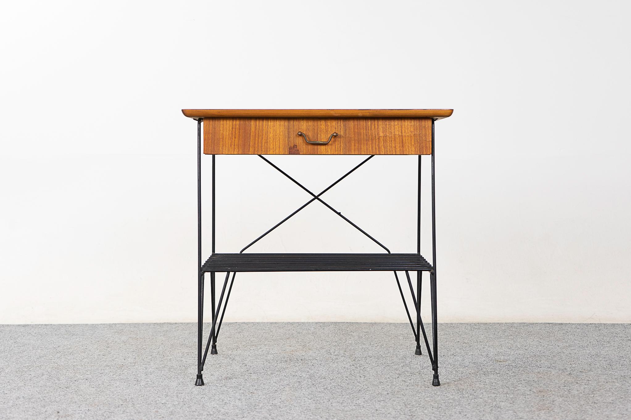 Teak & metal Danish bedside table, circa 1960's. Veneered case on slender hairpin base. Sleek drawer and airy shelf, a practical little piece!

For remote and international shipping rates.