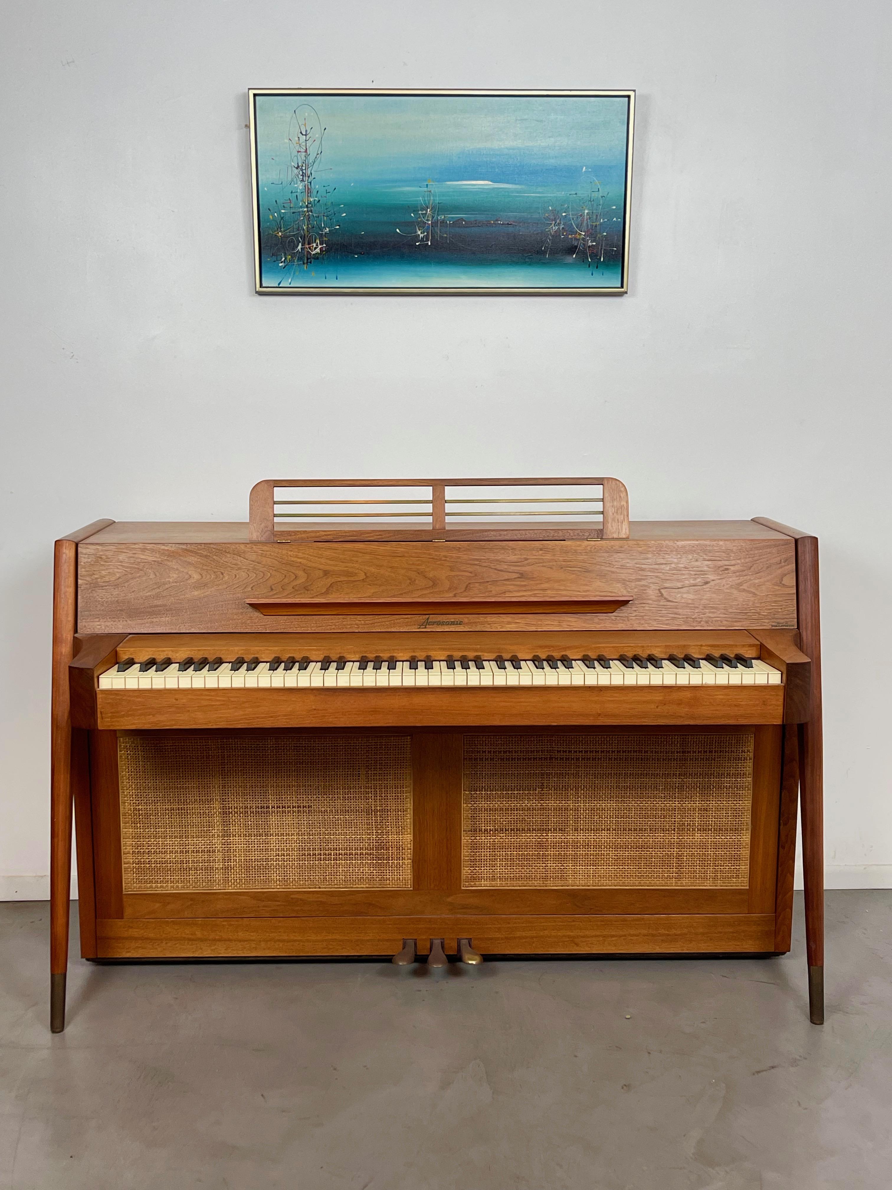 Rare stunning mid-century danish modern Acrosonic spinet piano made by Baldwin. Its Danish modern tapered leg design and solid teak wood cabinet makes it as much a work of art as it is a musical instrument. Covered front and back with beautiful