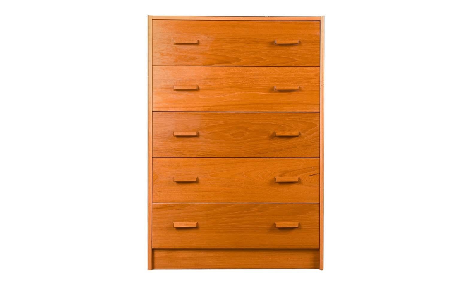 Mid-Century Modern teak high boy dresser, chest of drawers, made in Denmark. Minimalist Danish Modern inspired profile and extremely well-made dresser, has incredible lines and detailing. Stunning teak grain high boy dresser accented with sculpted
