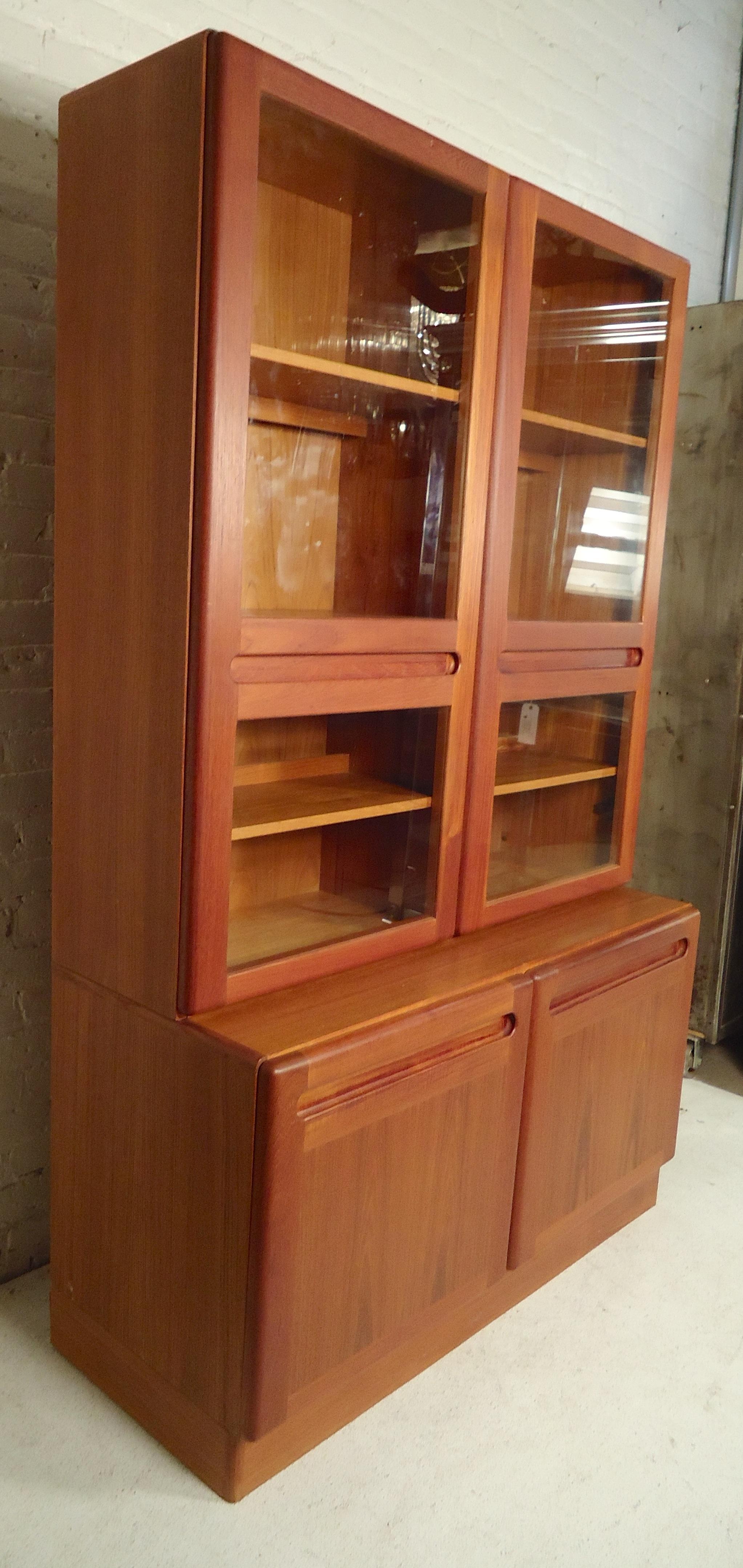 Stacked bookcase with cabinet base. Glass doors with sculpted handles and recessed lighting inside.

(Please confirm item location - NY or NJ - with dealer).
 