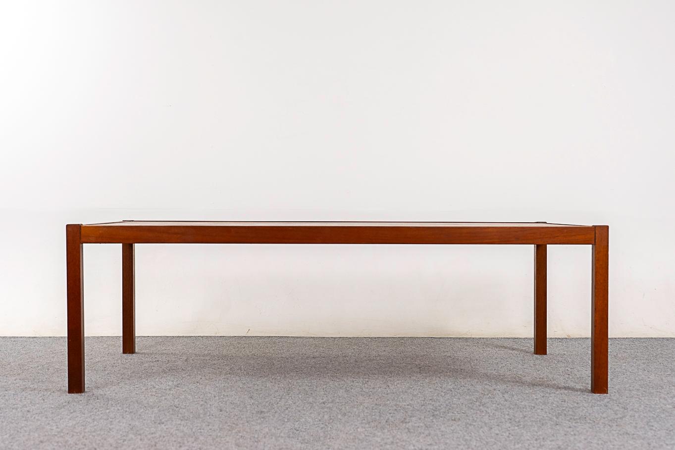 Teak mid-century coffee table, circa 1970's. Low table with slim legs and generous proportions. Games night is on! 

Unrestored item with option to purchase in restored condition for an additional $100 USD. Restoration includes: repairs, sanding,
