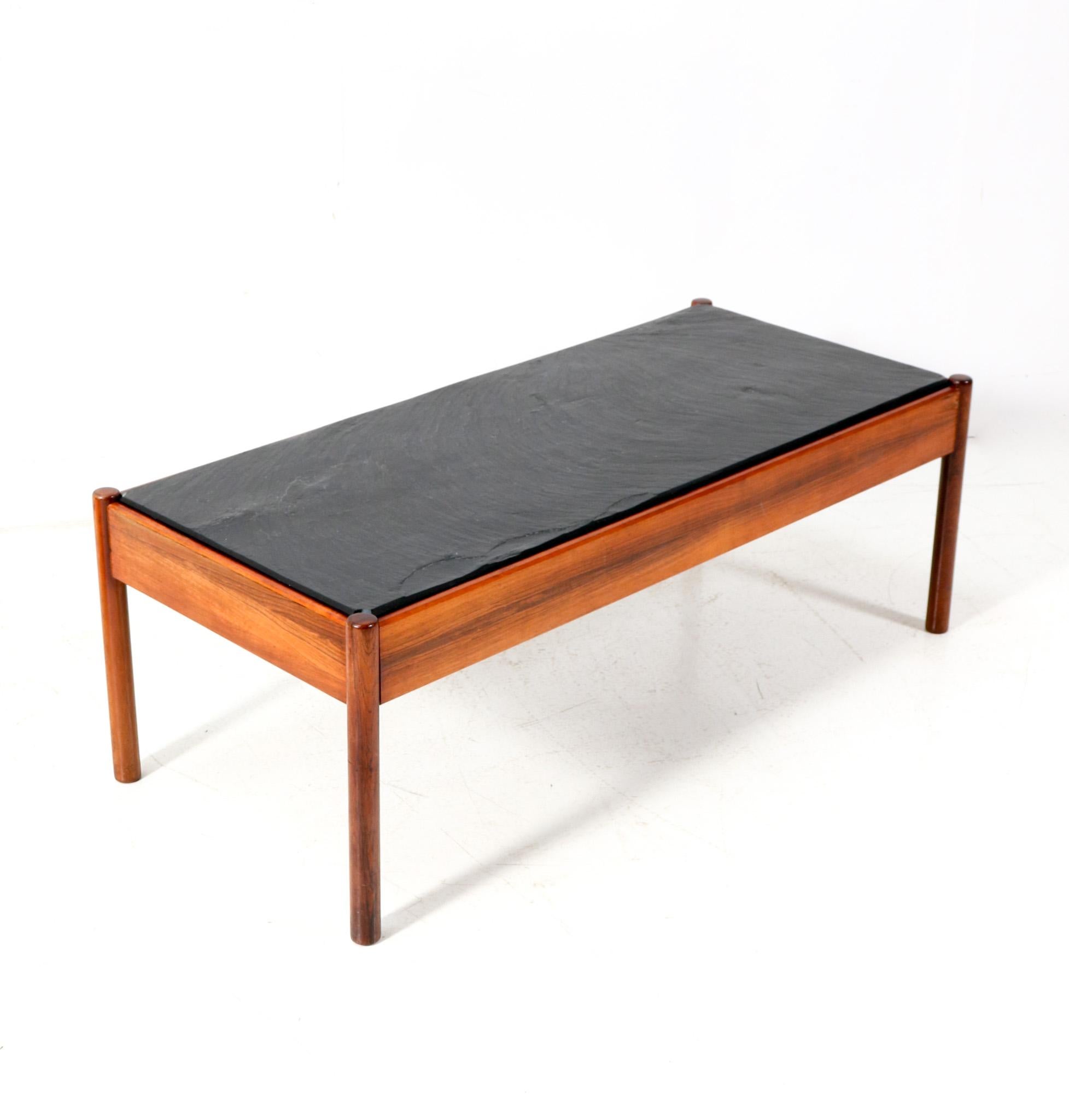 Stunning and elegant Mid-Century Modern coffee table or cocktail table.
Striking Dutch design from the 1960s.
Solid teak frame with original slate top.
This wonderful Mid-Century Modern coffee table or cocktail table is in very good original