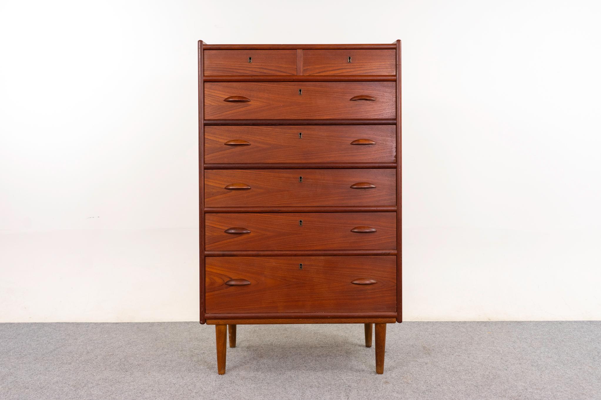 Teak dresser, circa 1960's. Horizontal bookmatched veneer and curved solid teak trim Unique design features a lock on each drawer! Darling curved handles.

An unrestored item with the option to purchase in restored condition for an additional $300