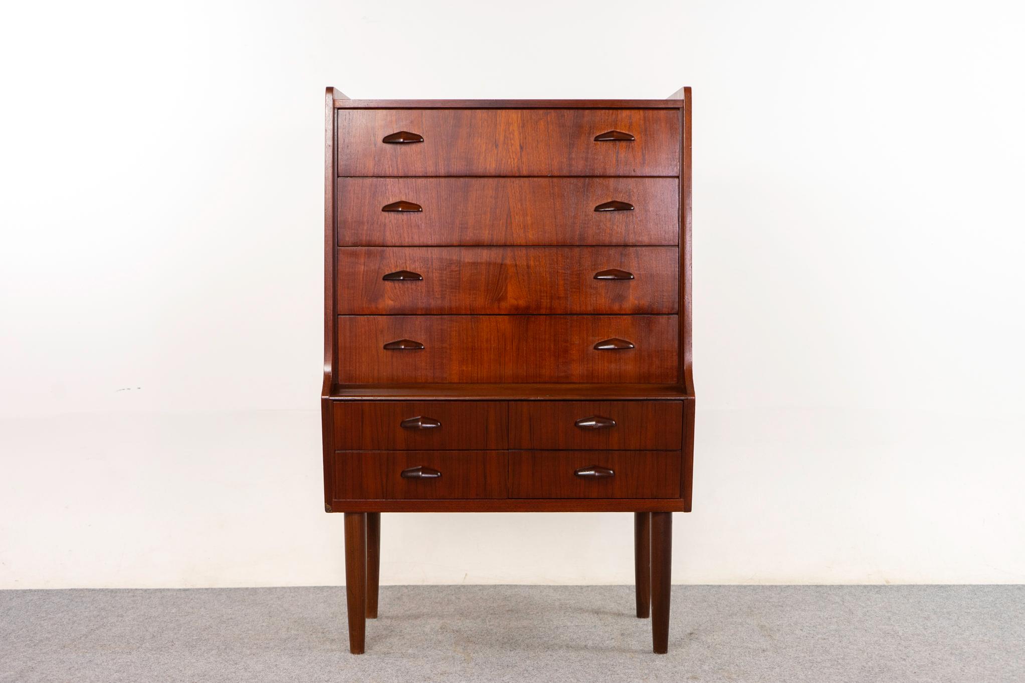 Teak Danish dresser/vanity circa 1960's. Solid wood edging with stunning book-matched veneer and robust tapered legs. Unique integrated drop down vanity drawer with flip up mirror and sleek shelf. 

Unrestored item with option to purchase in