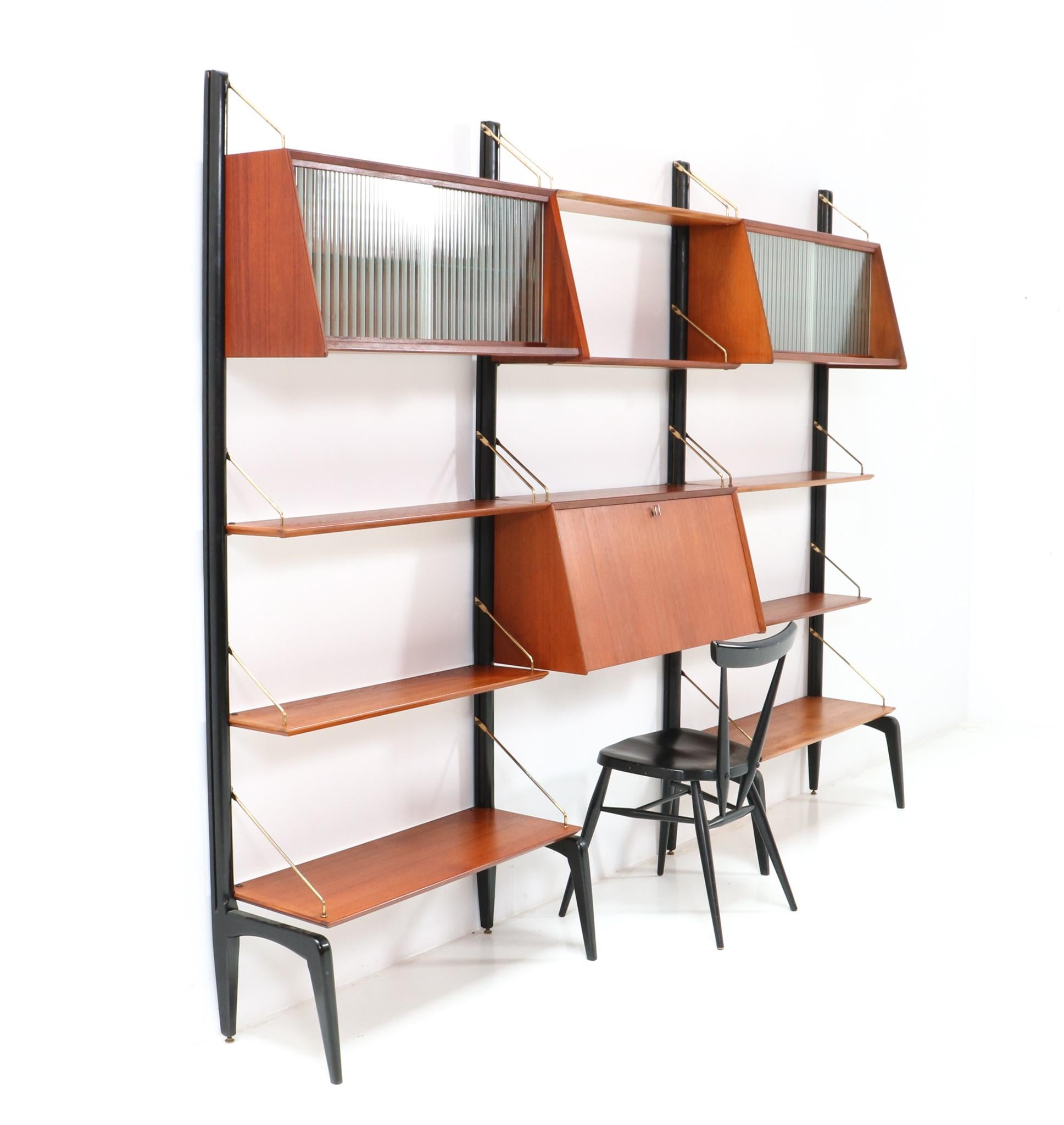 Stunning and rare Mid-Century Modern free standing modular wall unit.
Design by Louis van Teeffelen for WéBé
Striking Dutch design from the 1950s.
Rare because of the fact that this configuration has two cabinets with the original glass sliding