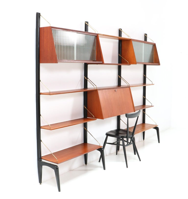 Stunning and rare Mid-Century Modern free standing modular wall unit.
Design by Louis van Teeffelen for WéBé
Striking Dutch design from the 1950s.
Rare because of the fact that this configuration has two cabinets with the original glass sliding
