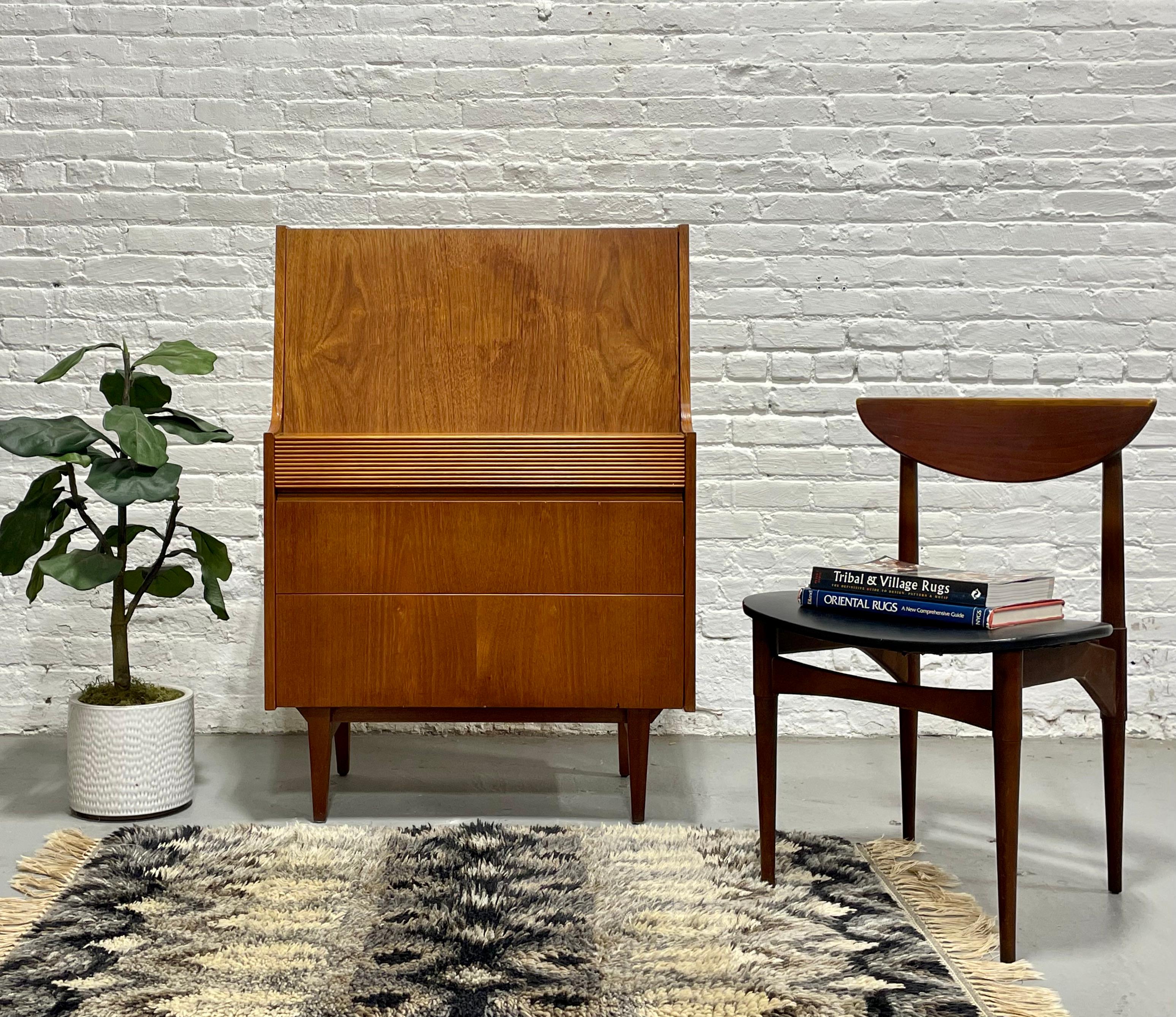 Vintage Mid century Modern Teak Secretary desk + dresser by Elliotts of Newbury, Made in the UK, c. 1960's.  This piece boasts tons of delicious design details: three deep and spacious dovetailed drawers below and a drop down desk, plus additional