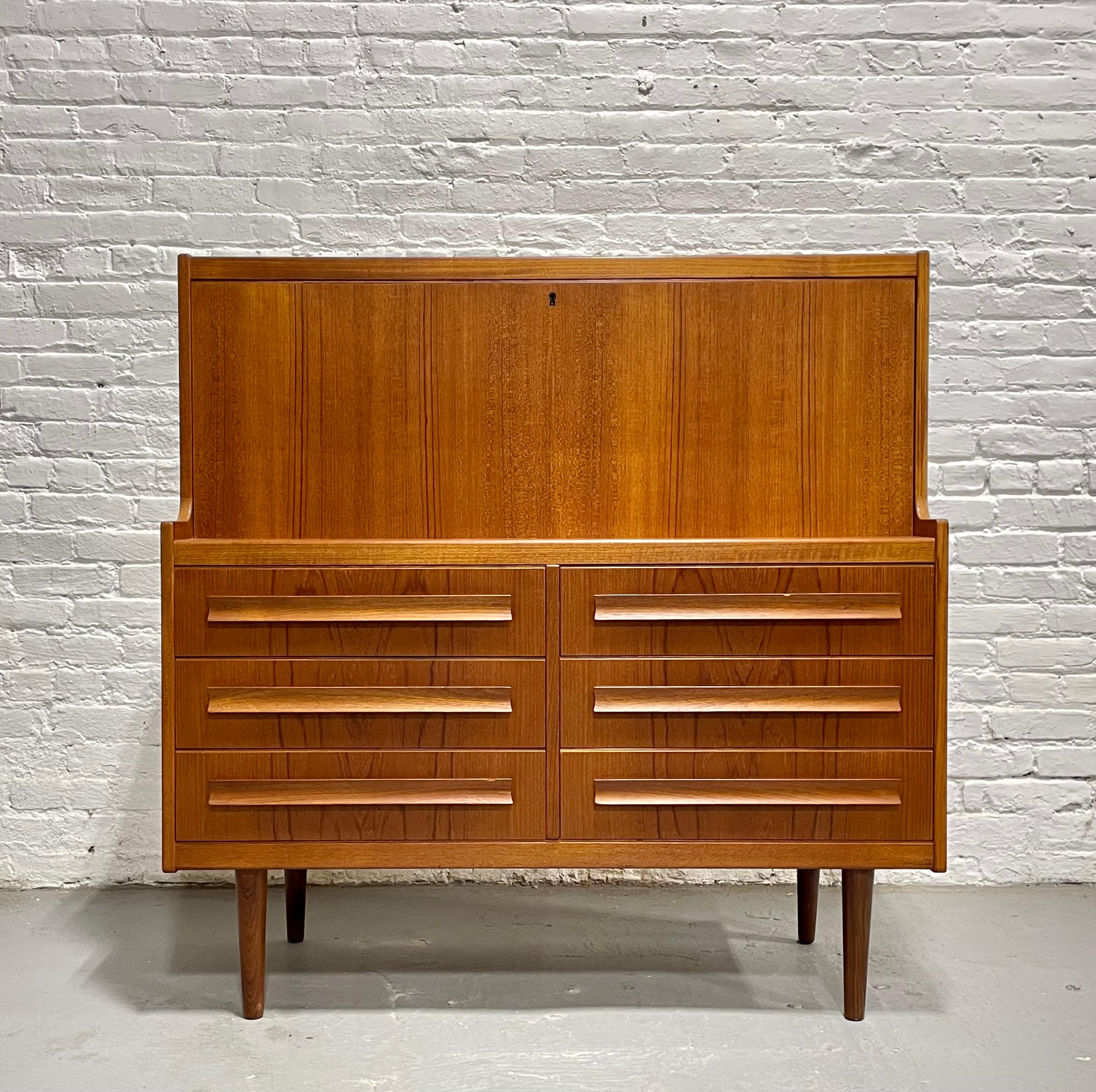 Vintage Mid Century Modern Teak Secretary Desk + Storage, Made in Denmark, c. 1960's. This piece boasts tons of delicious design details: upper area has a lockable drop down desk with storage cubbies and drawers within, perfect for storing all your