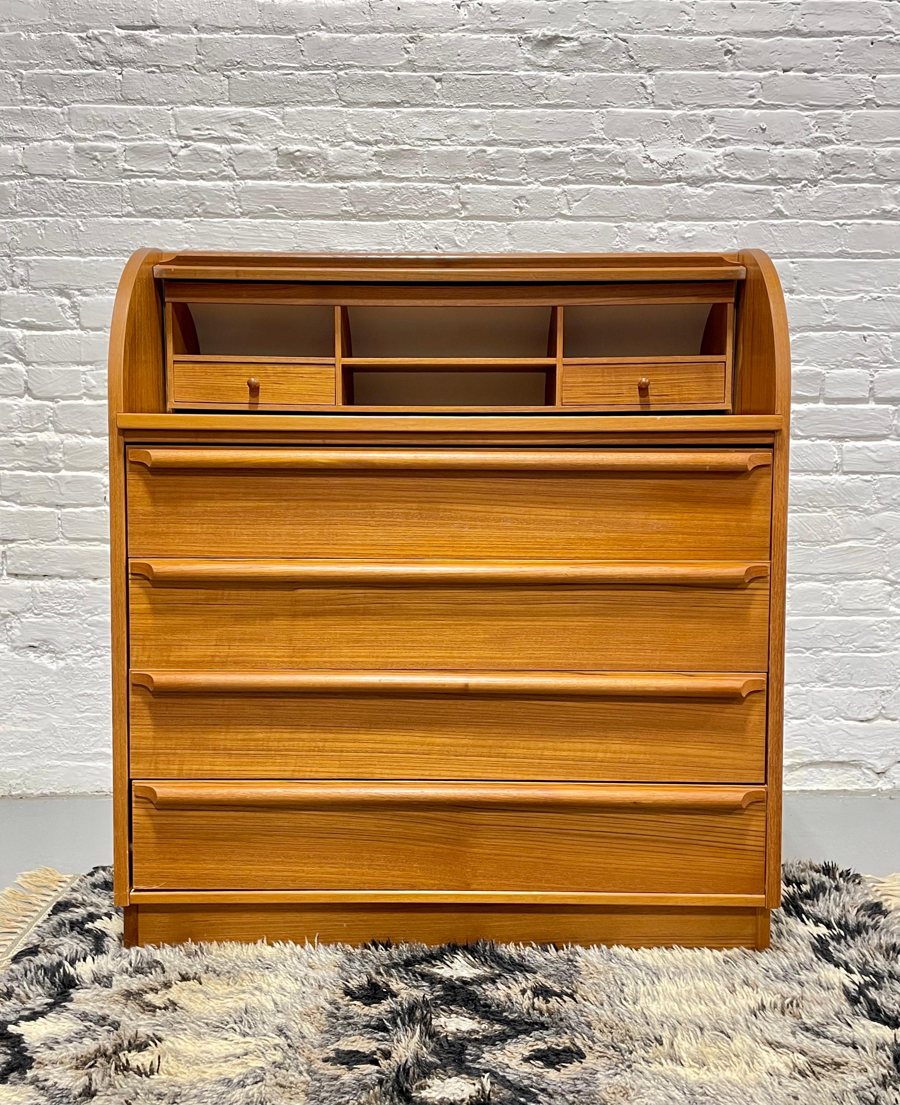 Vintage Mid century Modern Teak Secretary desk, Made in Denmark. This piece boasts tons of storage space in the four deep and spacious drawers and above there is a hidden pull out desk plus additional storage cubbies for all your supplies. Pull up a