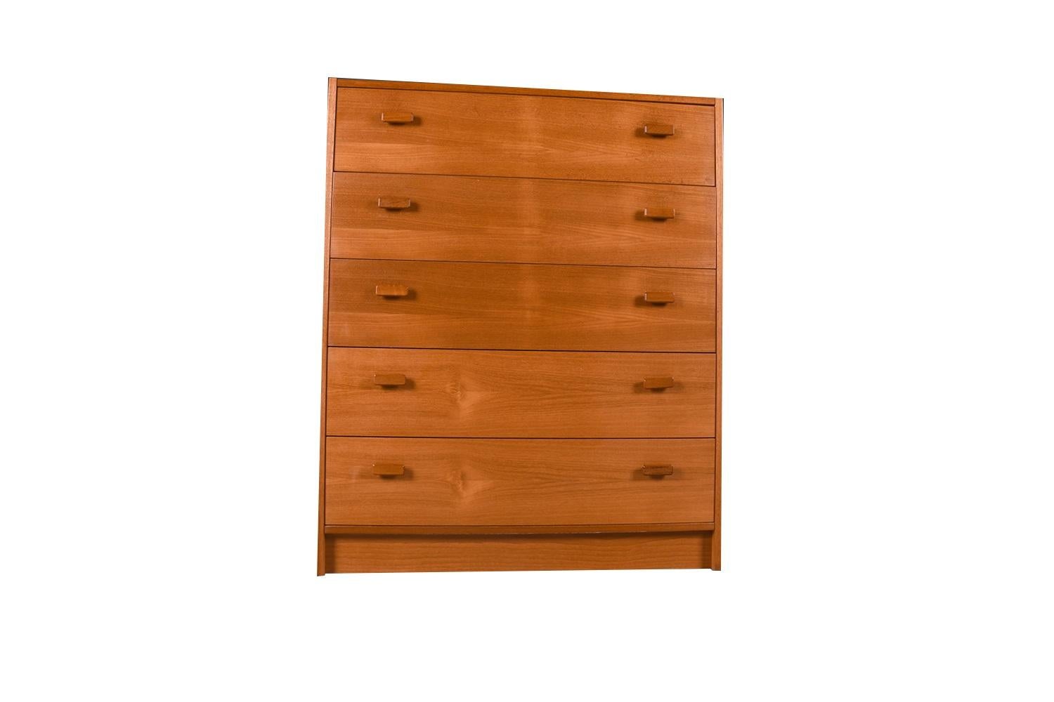 Mid-Century Modern teak high boy dresser, chest of drawers, made in Denmark. Minimalist Danish Modern inspired profile and extremely well-made dresser, has incredible lines and detailing. Stunning teak grain high boy dresser accented with sculpted