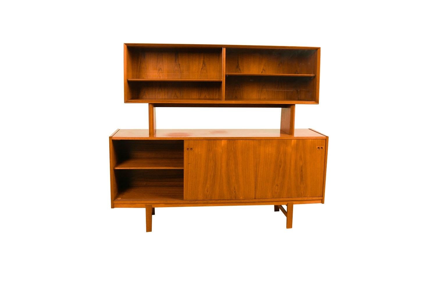 Remarkable, teak, stunning sliding glass doors, two-piece hutch credenza made in Denmark.  This Danish Modern teak credenza /hutch is beautifully embellished with bands of teak running perpendicular to the main surface. Precisely crafted in