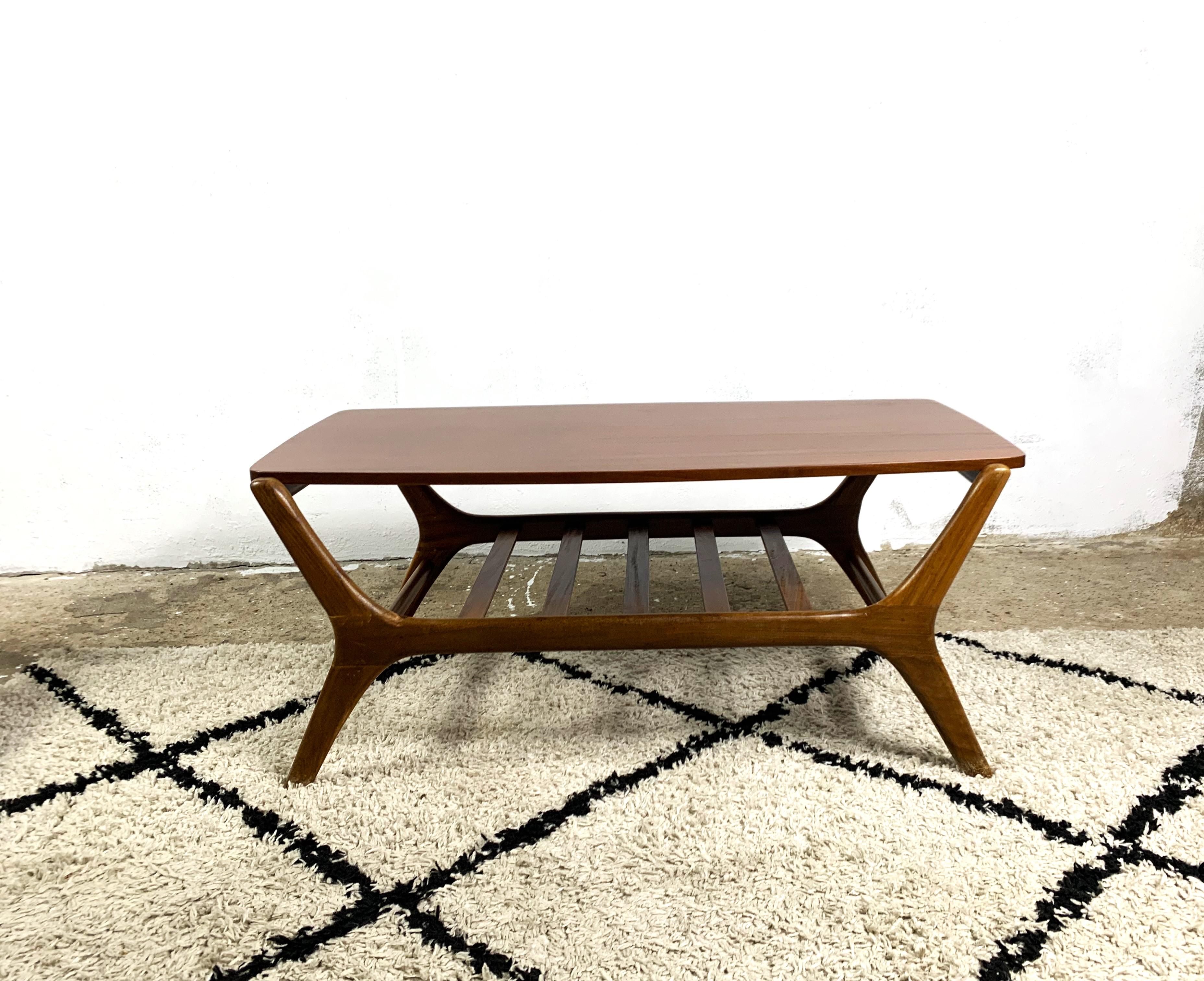 Beautiful small coffee table, base made of solid teak, double-sided top, veneered with teak on one side and formica on the other. The style indicates the authorship of the outstanding Dutch designer Louis van Teeffelen. the table has been renovated,
