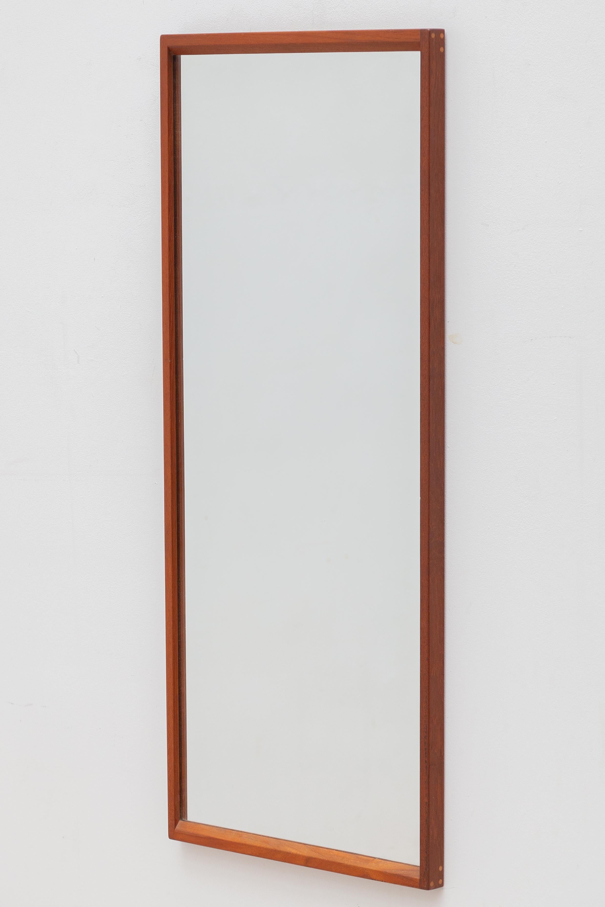 1960s wall mirror designed and manufactured by Aksel Kjersgaard in Danish municipality of Odder. Very well crafted design, utilizing masterful joinery techniques and Kjersgaard's signature circular inset plugs that serve both the construction and