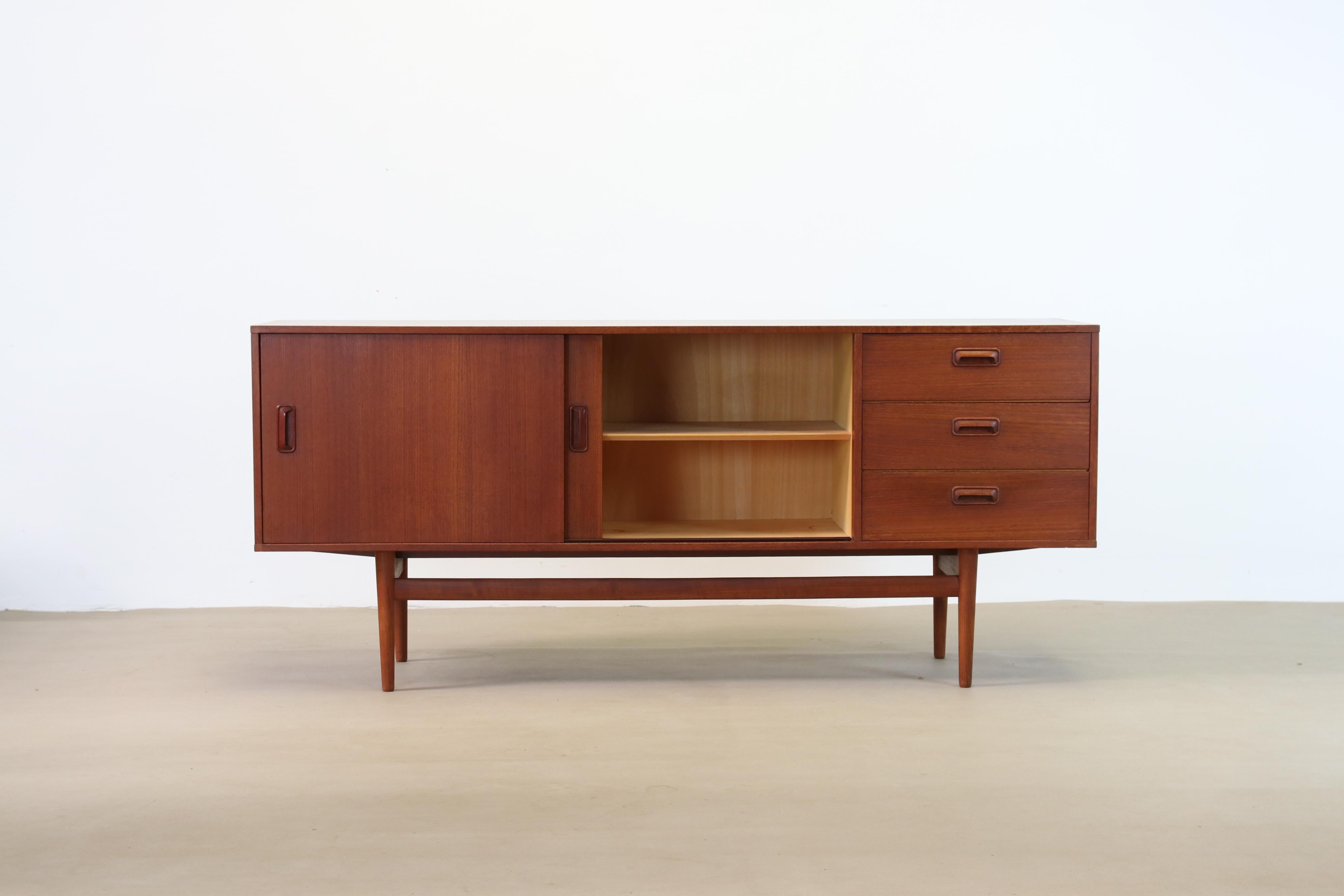 Beautiful sideboard from the German manufacturer Musterring Mobel from the 1960s. Made of teak and designed in the Danish style. The sideboard stands on high slender legs, which makes this sideboard look light, but still has a lot of storage space