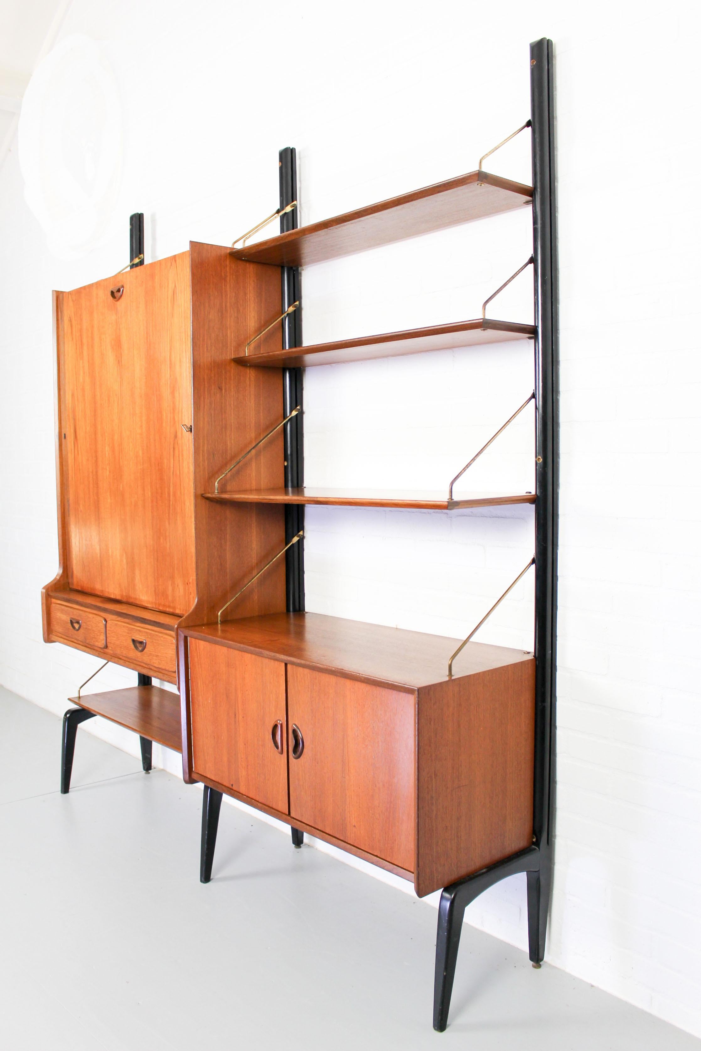 Modular wall unit by Van Teeffelen for WeBe, 1950s. This well detailed wall system was designed by Dutch designer Louis Van Teeffelen and produced by WéBé Holland. This super shaped, Danish organic inspired wall unit has black ant shaped feet, teak