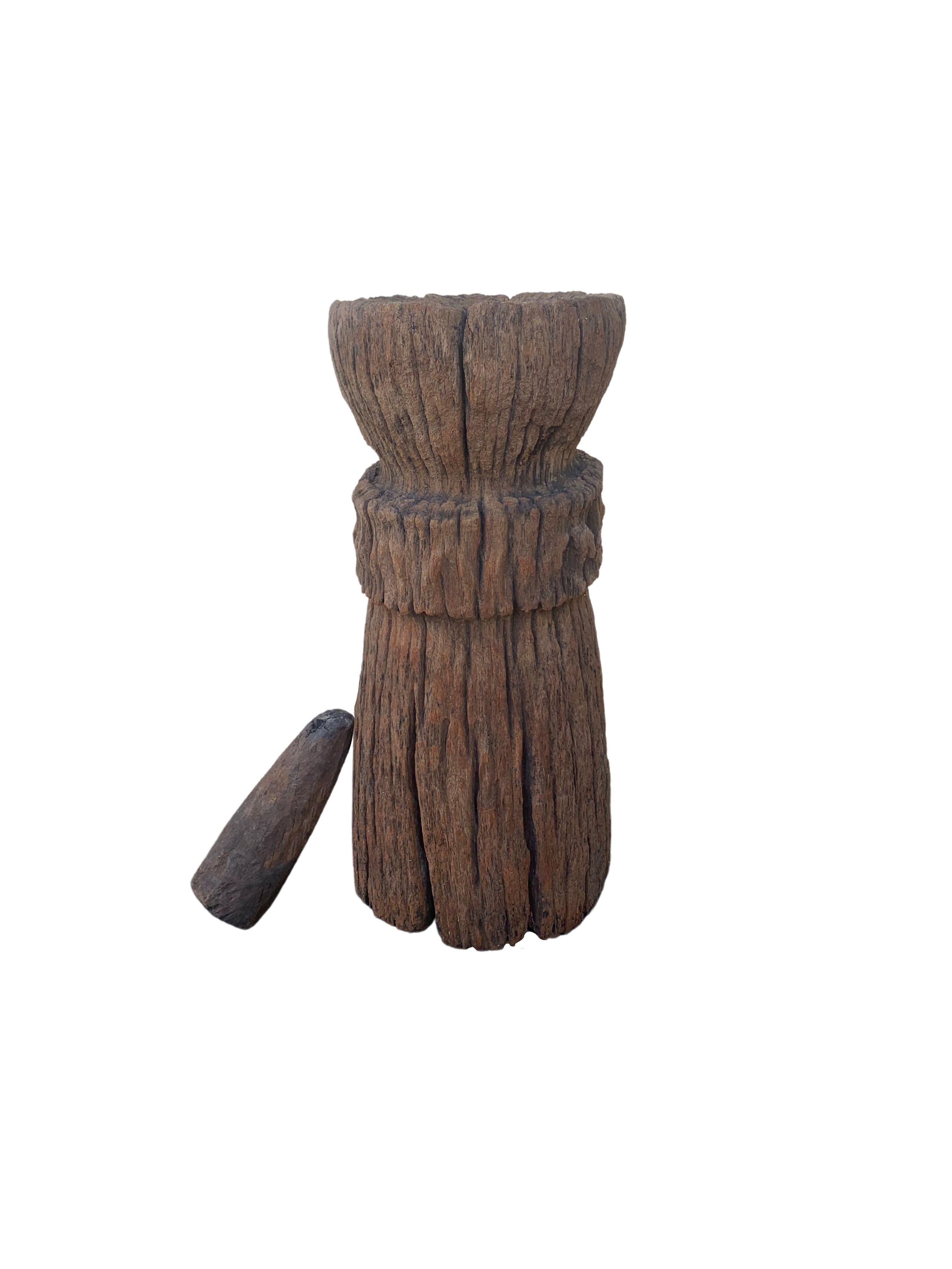 A visibly old mortar soured from rural Java & crafted from a solid teak wood slab. A raw and organic object with beautiful wood textures and imperfections. A versatile decorative object to bring warmth and life to any space, despite its once