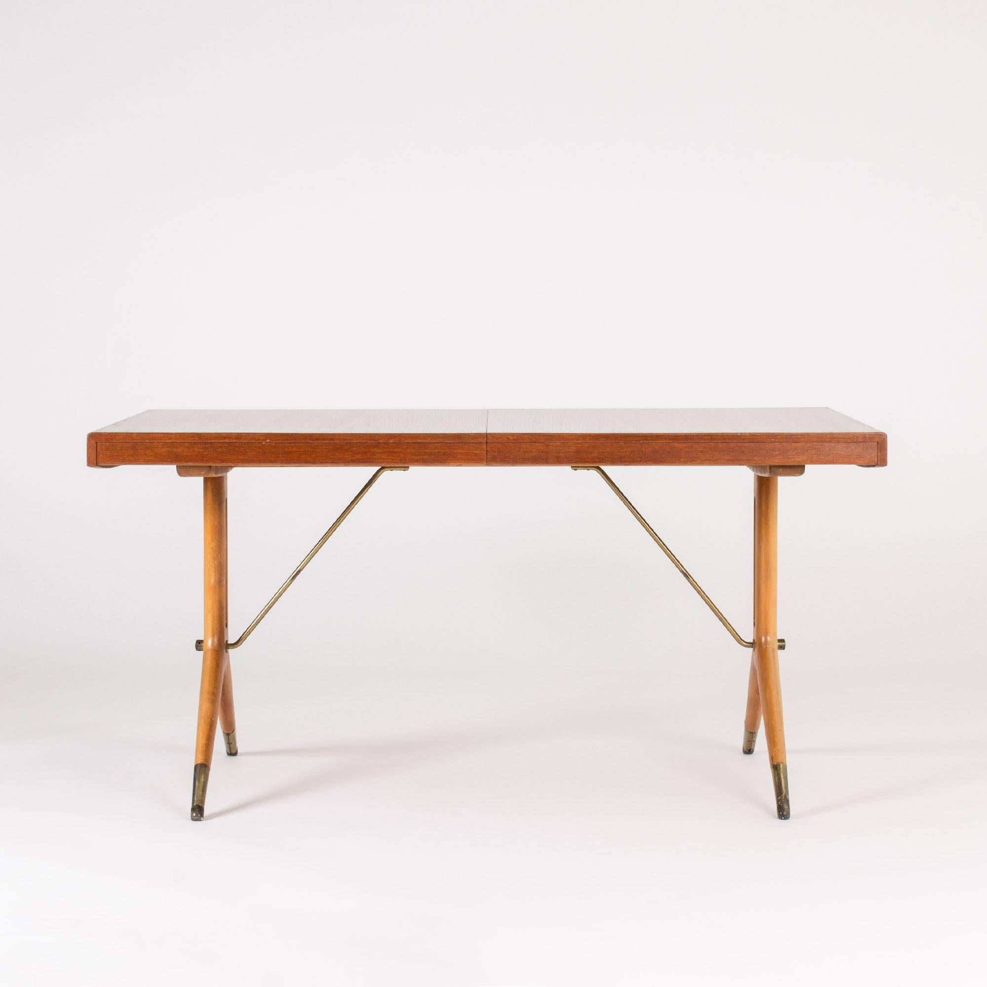 Beautiful “Napoli” dining table by David Rosén. Teak tabletop and elegantly sculpted beech legs with brass details. Two extra leaves makes this a versatile table that looks great in all lengths.
Measures: Depth 145 + 45 + 45 cm.